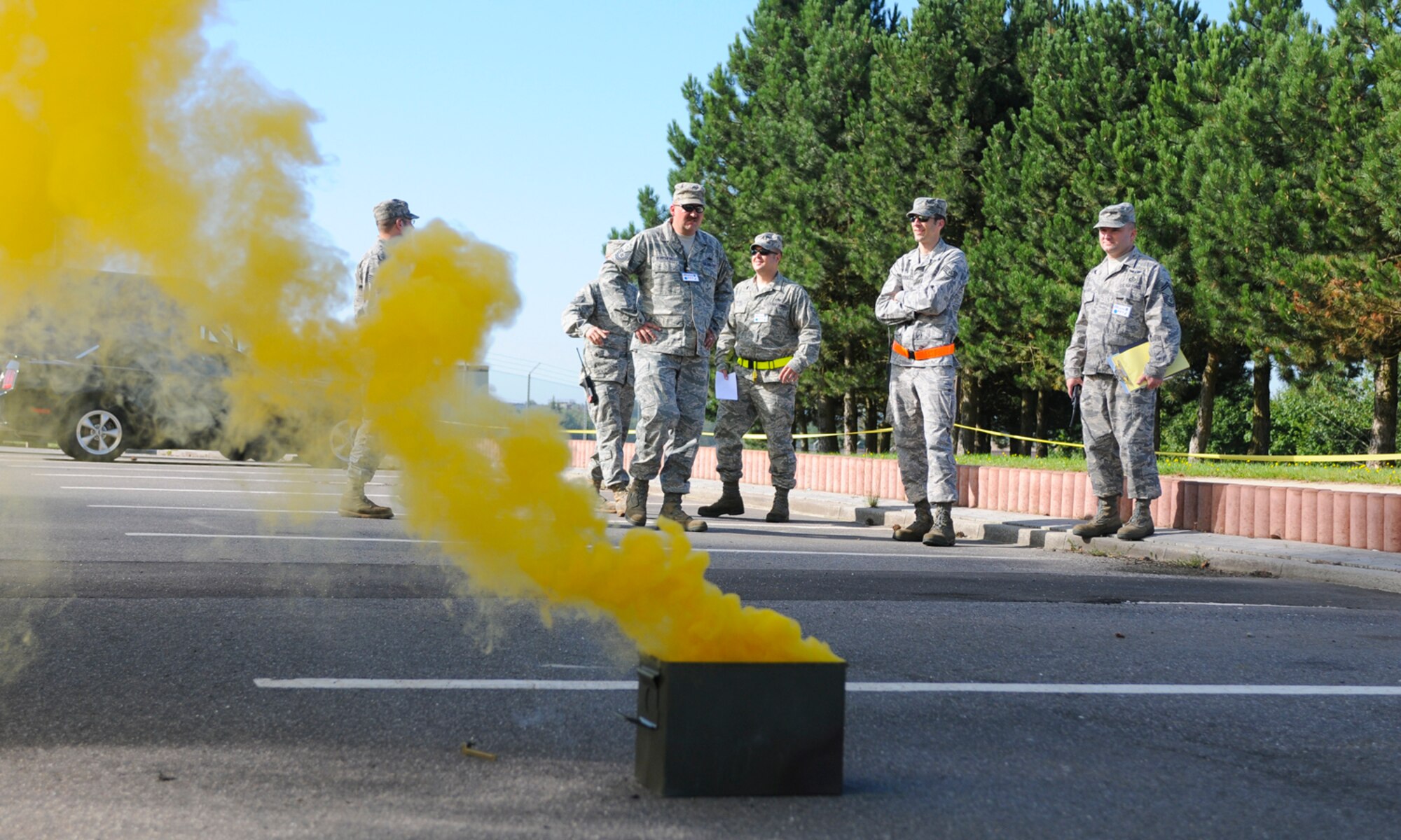 SPANGDAHLEM AIR BASE, Germany -- Members of the exercise evaluation team watch as smoke blows towards the 81st Fighter Squadron Aug. 4. The smoke alerted members of the 81st FS to take appropriate action against the simulated attack during the 52nd Fighter Wing’s Phase II exercise. (U.S. Air Force photo/Airman 1st Class Nathanael Callon)