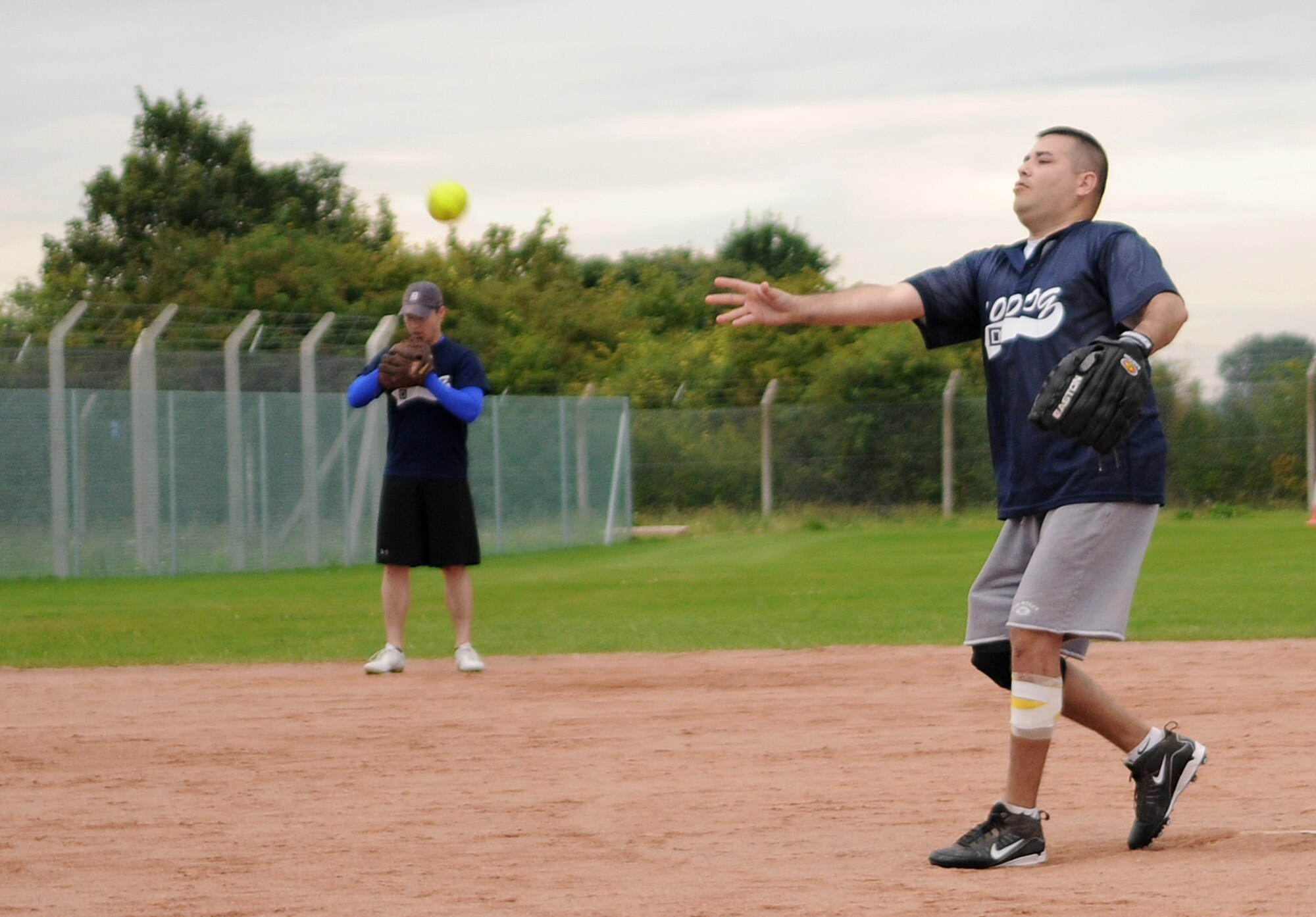 RAF MILDENHALL, England -- Peter Rodriguez, 100th Operations Group assistant coach, pitches in the Mildenhall Intramural Softball Championship Aug. 4. The 100th OG took home the winning title after a two-game run against the combined 95th Reconissance Squadron and 488th Intelligence Squadron team. Both games were over in less than an hour and a half and finished with a 19-2 blowout. (U.S. Air Force photo by Senior Airman Thomas Trower)