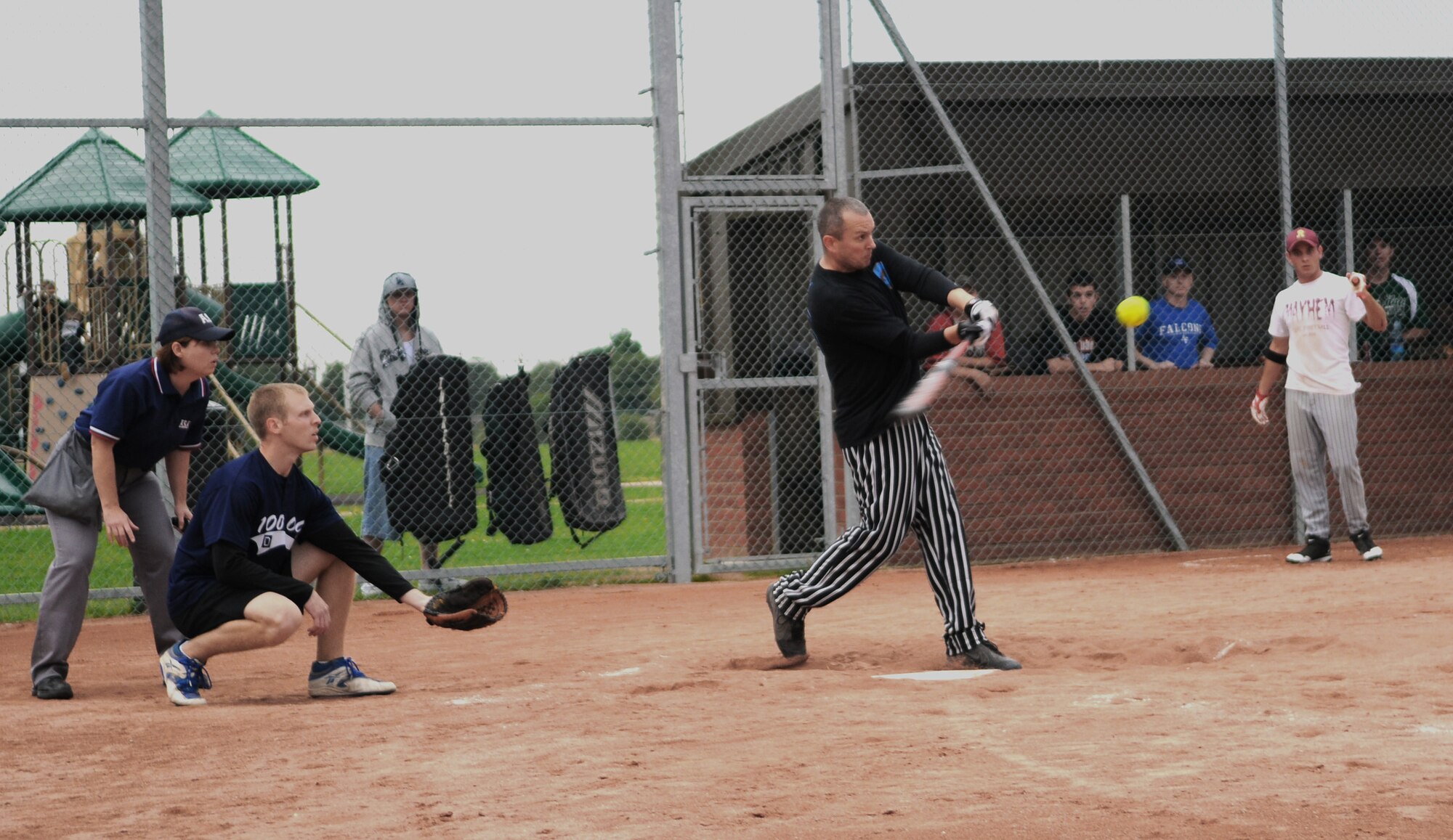 RAF MILDENHALL, England -- Gary Cabrall, 488th Intelligence Squadron player, bats during the Mildenhall Intramural Softball Championship Aug. 4 on the south side of base. The combined 488th IS and 95th Reconnaissance Squadron team attempted to mirror a previous victory against the 100th Operations Group team earlier in the season, however, the 100th OG powered through in a two-game run to take the first place trophy home with a 19-2 victory. (U.S. Air Force photo by Senior Airman Thomas Trower)
