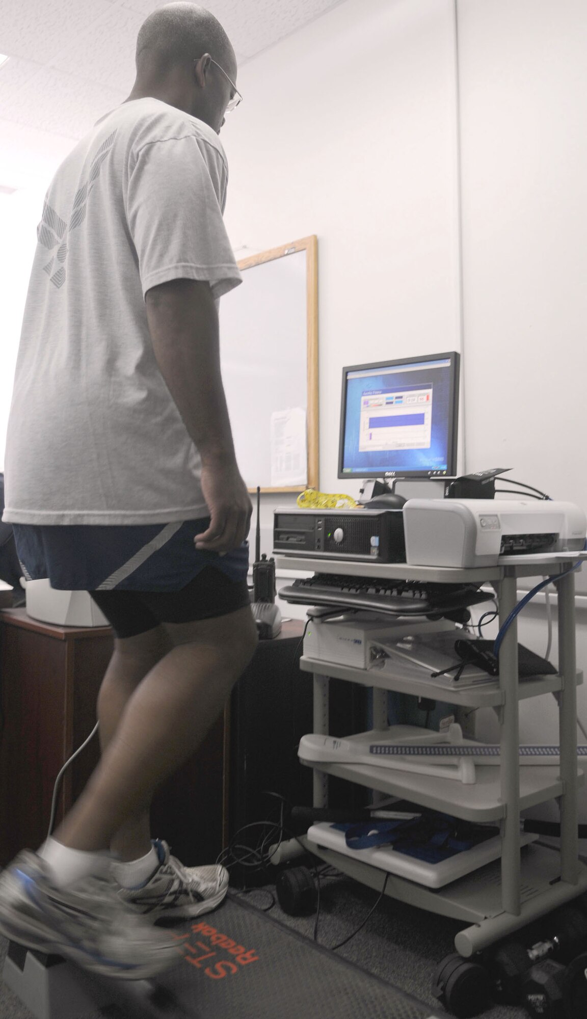 Chief Master Sgt. Robert Ellis, the 39th Air Base Wing command chief, step exercises during the heart rate portion of the MicroFit fitness assessment program Wednesday, Aug. 5, 2009, in the fitness center. A trained fitness monitor helps participants follow several steps to assess their fitness level. The program is now available to people who have valid access to the fitness center with a military identification card. (U.S. Air Force photo/Senior Airman Alex Martinez)