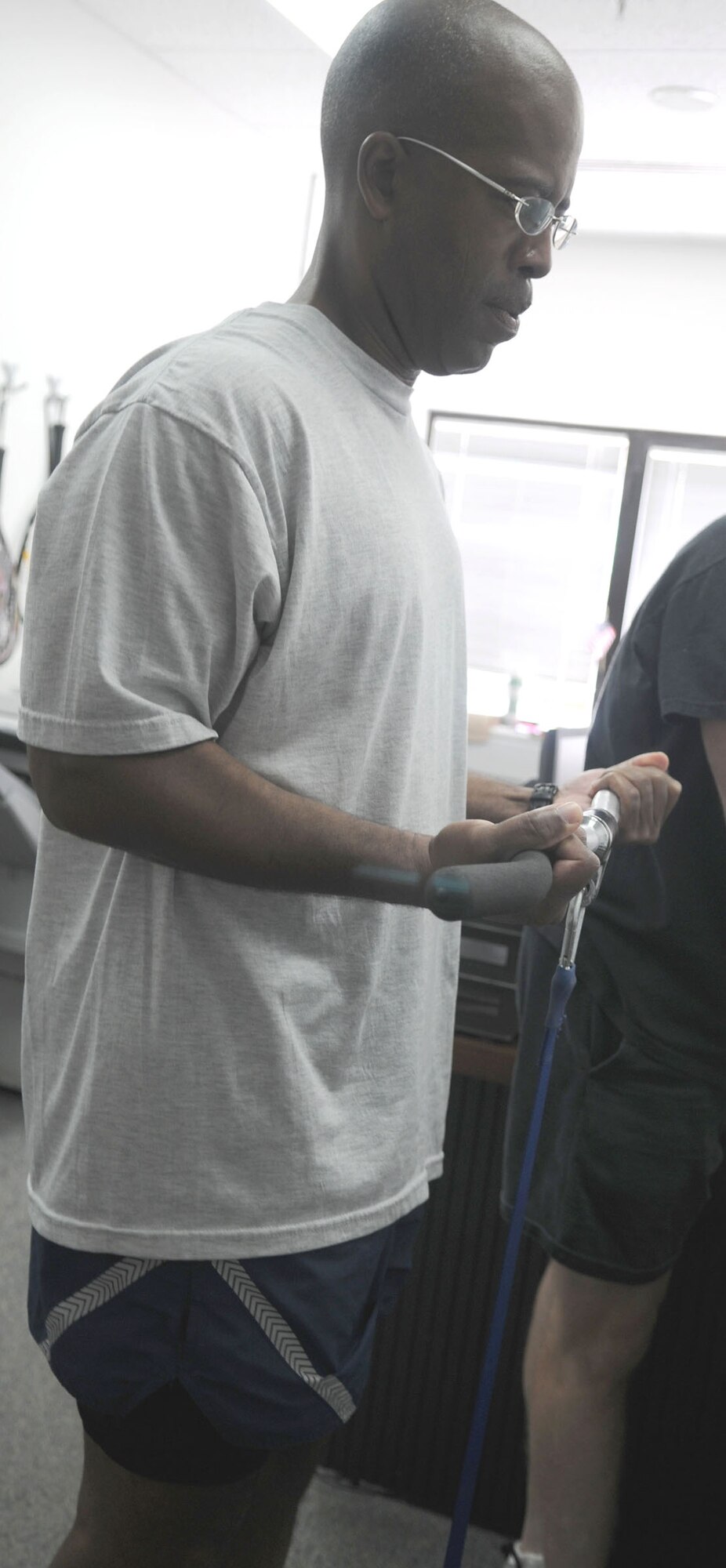 Chief Master Sgt. Robert Ellis, the 39th Air Base Wing command chief, completes the strength portion of the MicroFit fitness assessment program Wednesday, Aug. 5, 2009, in the fitness center. A trained fitness monitor helps participants follow several steps to assess their fitness level. The program is now available to people who have valid access to the fitness center with a military identification card. (U.S. Air Force photo/Senior Airman Alex Martinez)