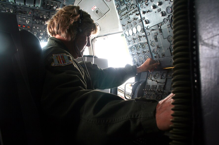 Senior Master Sgt. Sara Galvin, a KC-10 Extender flight engineer from the 9th Air Refueling Squadron at Travis Air Force Base, Calif., works on the flight deck of a KC-10 during a flight back to California from Scott AFB, Ill., on Aug. 4, 2009.  The KC-10 is one of Air Force's and Air Mobility Command's air refueling aircraft that helps provide global reach and the Air Force to fly, fight and win...in air, space and cyberspace.  Sergeant Galvin has more than 10,000 flying hours as a flight engineer. (U.S. Air Force Photo/Tech. Sgt. Scott T. Sturkol)