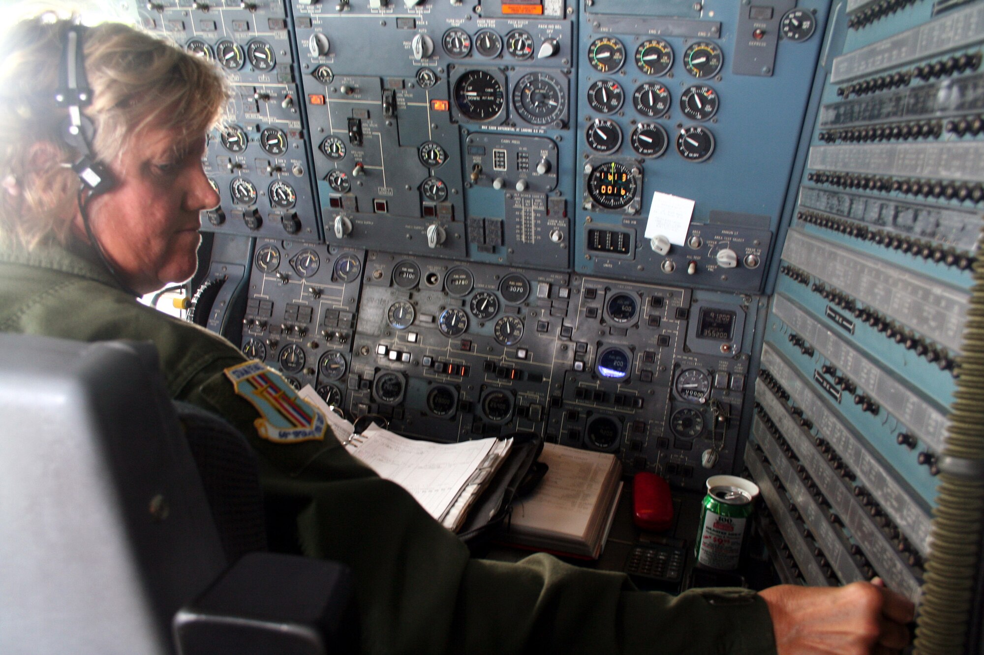 Senior Master Sgt. Sara Galvin, a KC-10 Extender flight engineer from the 9th Air Refueling Squadron at Travis Air Force Base, Calif., works on the flight deck of a KC-10 during a flight back to California from Scott AFB, Ill., on Aug. 4, 2009.  The KC-10 is one of Air Force's and Air Mobility Command's air refueling aircraft that helps provide global reach and the Air Force to fly, fight and win...in air, space and cyberspace.  Sergeant Galvin has more than 10,000 flying hours as a flight engineer. (U.S. Air Force Photo/Tech. Sgt. Scott T. Sturkol)
