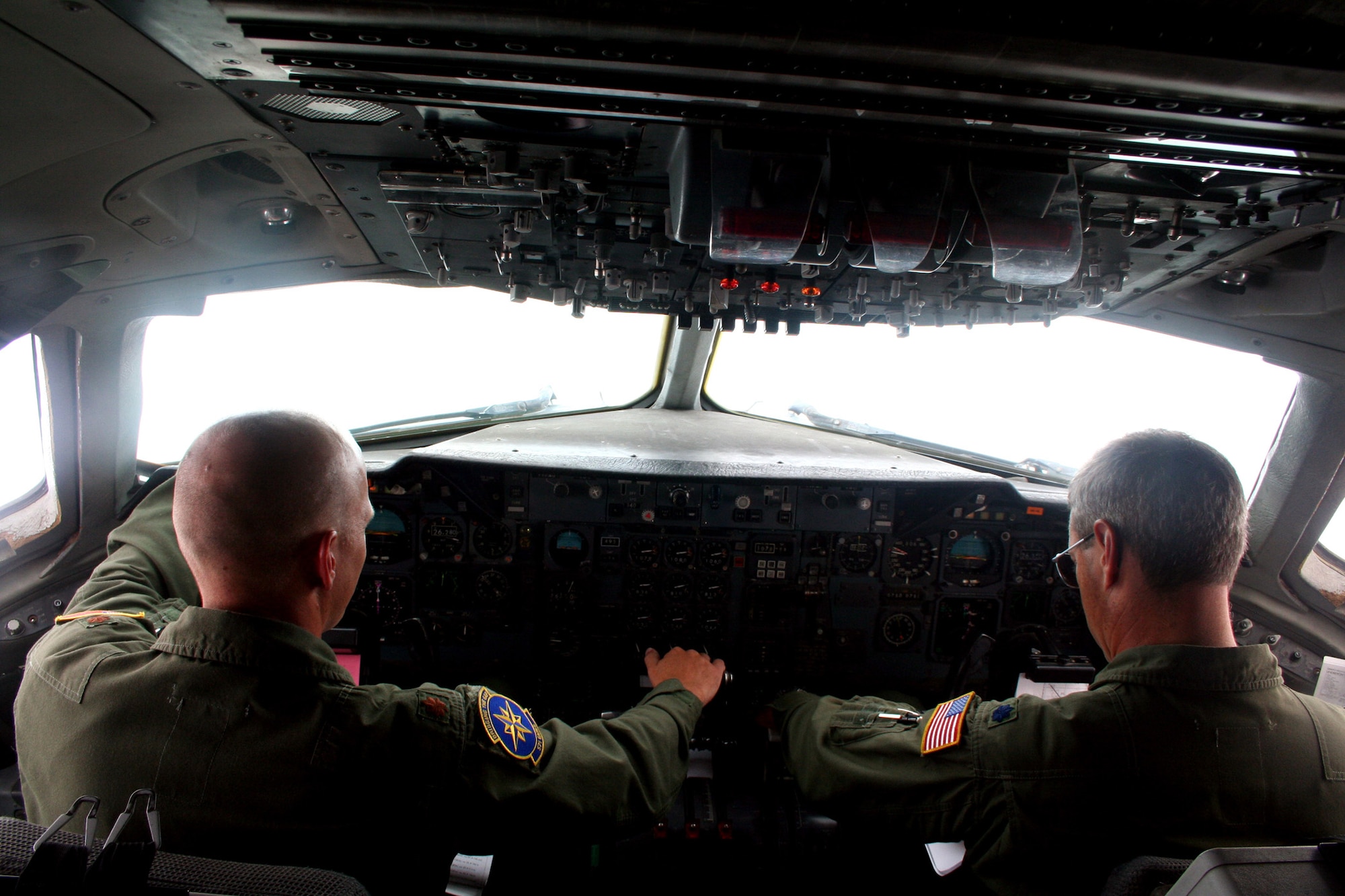 Maj. Jay Johnson (left) and Lt. Col. Chad Johnson (right), both KC-10 Extender pilots from Travis Air Force Base, Calif., fly a KC-10 back to California from Scott AFB, Ill., on Aug. 4, 2009.  The KC-10 is one of Air Force's and Air Mobility Command's air refueling aircraft that helps provide global reach and the Air Force to fly, fight and win...in air, space and cyberspace.  (U.S. Air Force Photo/Tech. Sgt. Scott T. Sturkol)
