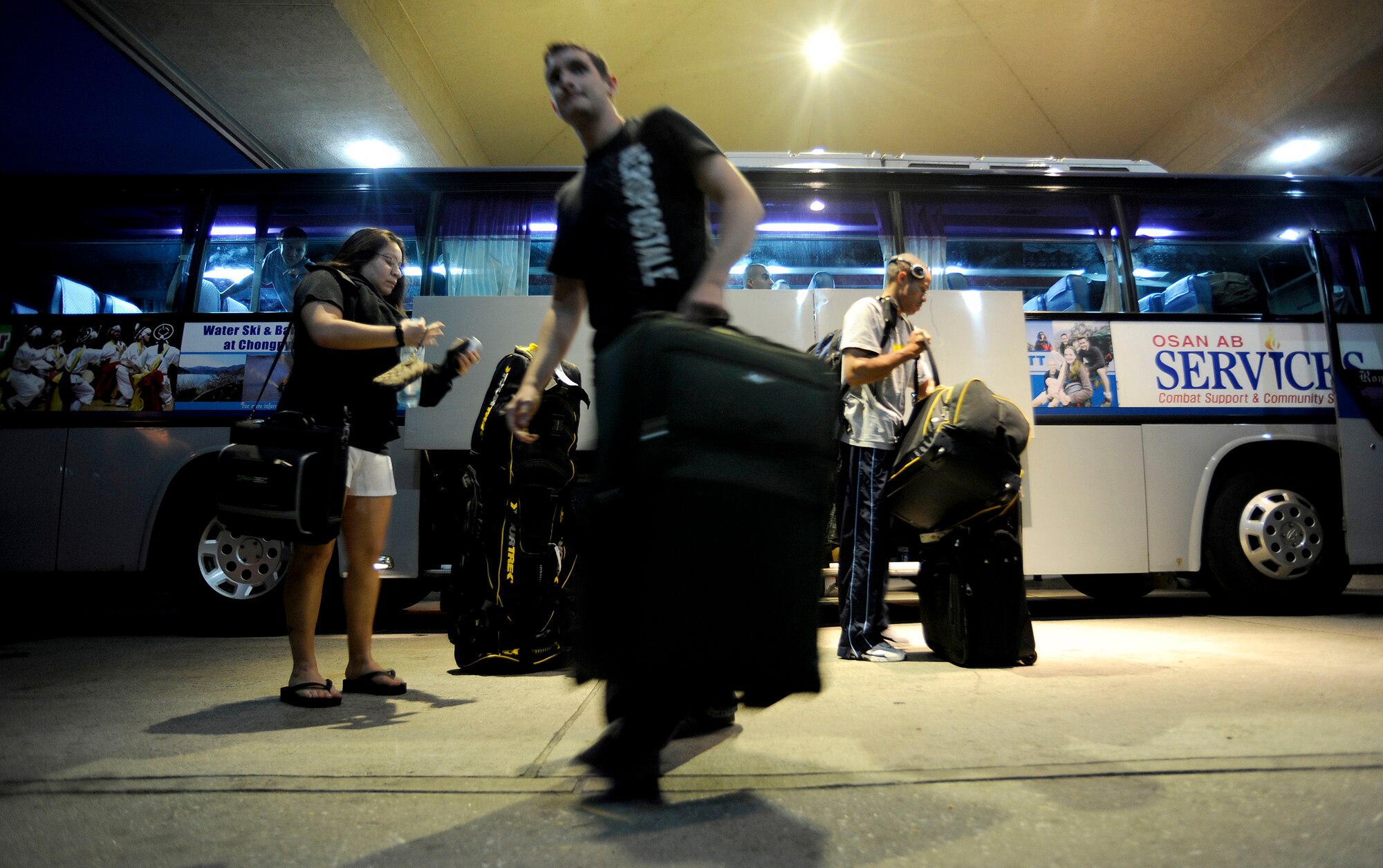 Guests of Turumi Lodge grab their luggage from a bus that transports military members from Incheon Airport to Osan Air Base, Republic of Korea.Voted the best lodging facility in the Pacific Air Force's for 2009, Turumi Lodge will now compete for the most prestigious lodging award in the Air Force: the Innkeeper award. The Air Force Innkeeper award is presented annually to recognize the lodging operation that provides the most outstanding hotel-type lodging and customer service to Air Force travelers. (U.S. Air Force photo/Staff Sgt. Brian Ferguson)