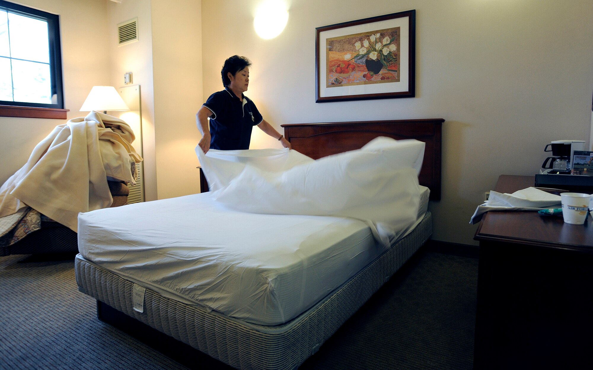 Housekeeper Hui Nang Chae changes the sheets on a bed at Turumi Lodge, Osan Air Base, Republic of Korea, Aug. 4. Voted the best lodging facility in the Pacific Air Force's for 2009, Turumi Lodge will now compete for the most prestigious lodging award in the Air Force: the Innkeeper award. The Air Force Innkeeper award is presented annually to recognize the lodging operation that provides the most outstanding hotel-type lodging and customer service to Air Force travelers. (U.S. Air Force photo/Staff Sgt. Brian Ferguson)