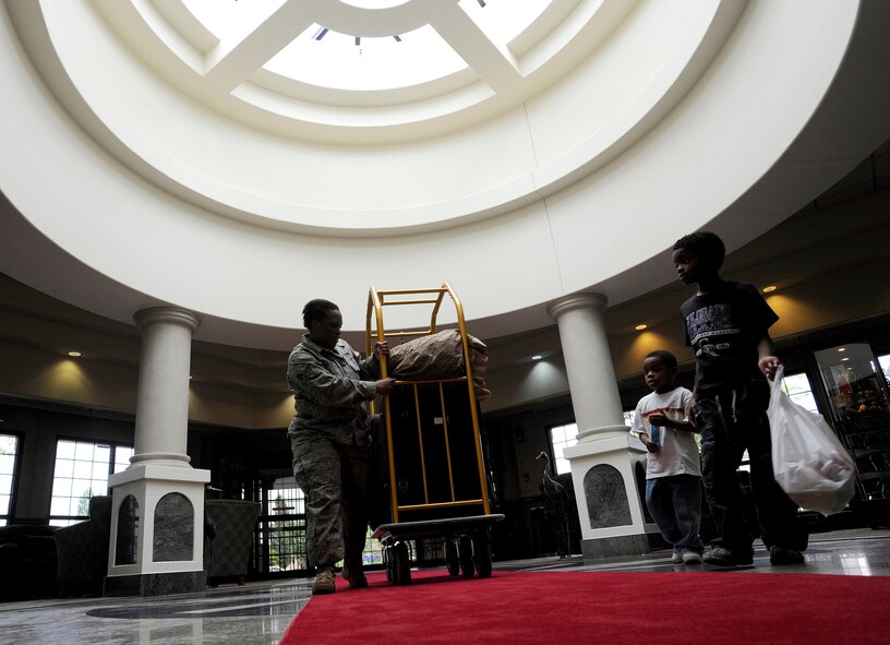 Senior Airman Clenena Parker wheels her luggage through the Turumi Lodge lobby, Aug. 4, as she prepares to depart Osan Air Base for Ramstein Air Base, Germany. Voted the best lodging facility in the Pacific Air Force's for 2009, Turumi Lodge will now compete for the most prestigious lodging award in the Air Force: the Innkeeper award. The Air Force Innkeeper award is presented annually to recognize the lodging operation that provides the most outstanding hotel-type lodging and customer service to Air Force travelers. (U.S. Air Force photo/Staff Sgt. Brian Ferguson)