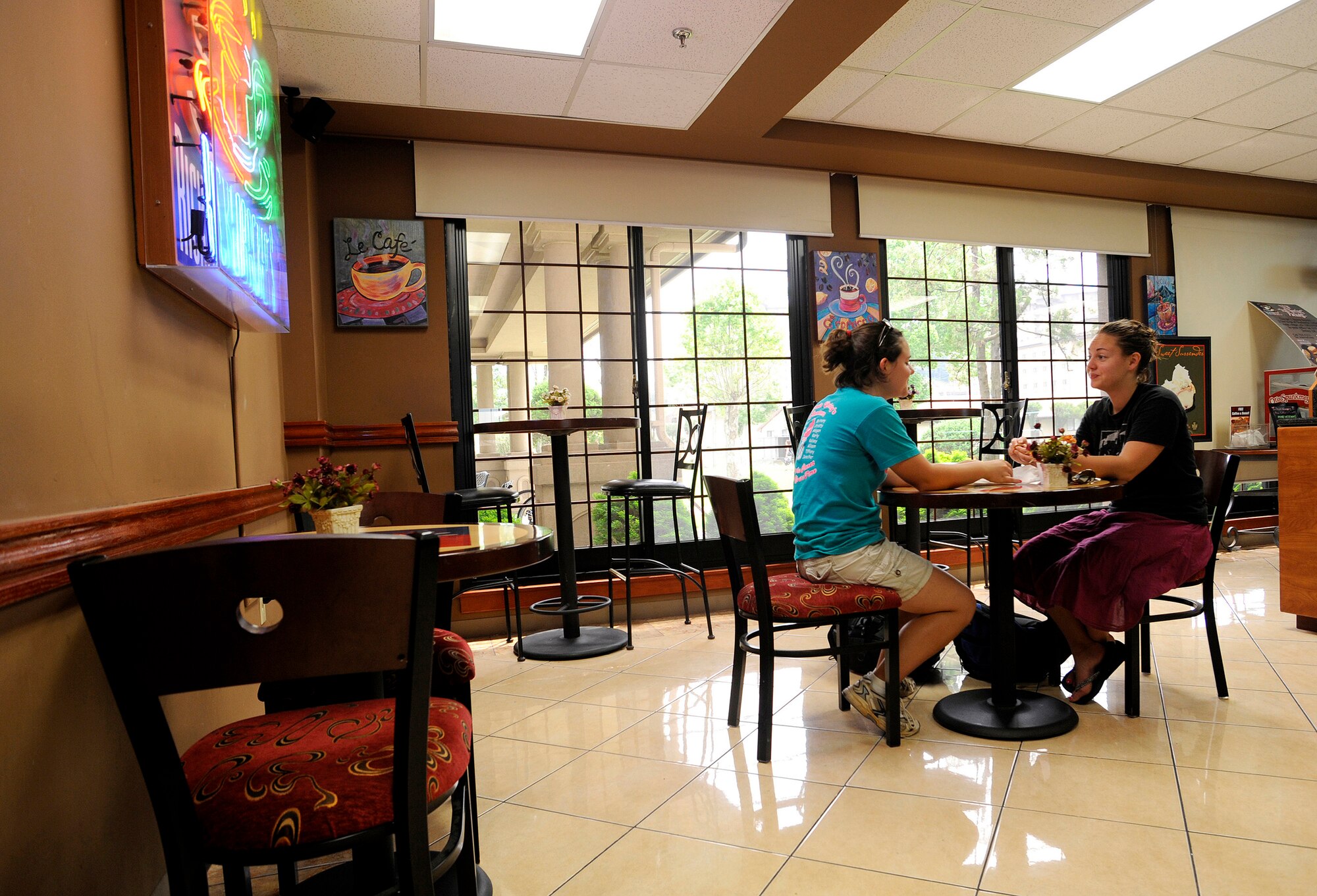 (Left) Jessica and Claire Glover enjoy a bran muffin at Rickenbacker's inside Turumi Lodge, Osan Air Base, Republic of Korea, Aug. 4. Voted the best lodging facility in the Pacific Air Force's for 2009, Turumi Lodge will now compete for the most prestigious lodging award in the Air Force: the Innkeeper award. The Air Force Innkeeper award is presented annually to recognize the lodging operation that provides the most outstanding hotel-type lodging and customer service to Air Force travelers. (U.S. Air Force photo/Staff Sgt. Brian Ferguson)