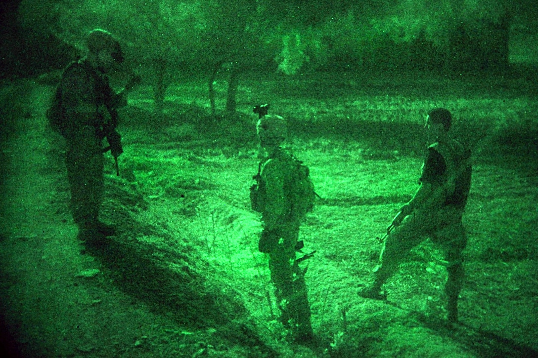 As seen through a night-vision device, U.S. Army Sgt. Andrew Burch tells Pfc. Frank Hardcastle and an Afghan National Army soldier how to orient themselves for security during Operation Champion Sword, an air assault mission, in Khost province, Afghanistan, Aug. 4, 2009. Burch and Hardcastle are assigned to the 25th Infantry Division’s 2nd Battalion, 377th Parachute Field Artillery Regiment, 4th Brigade Combat Team. International Security Assistance Forces and Afghan security forces teamed up to target specific militants in eastern Afghanistan.