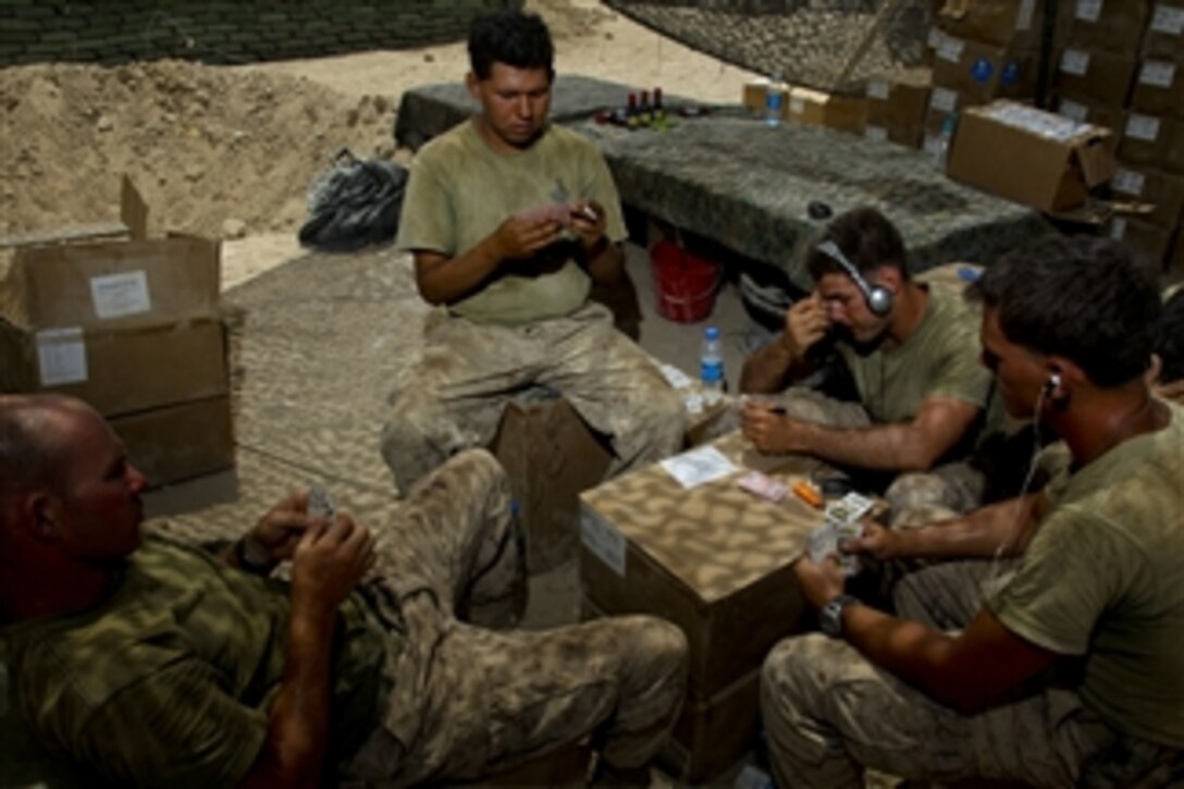 U.S. Marines with Alpha Company, 1st Battalion, 5th Marine Regiment play cards during their rest period at the company's forward operating base in the Nawa district of Helmand province, Afghanistan, on Aug. 5, 2009.  Marines with 1st Battalion, 5th Marine Regiment, Regimental Combat Team 3, 2nd Marine Expeditionary Brigade–Afghanistan are deployed in support of NATO's International Security Assistance Force and will participate in counter insurgency operations and the training and mentoring of Afghan security forces.  