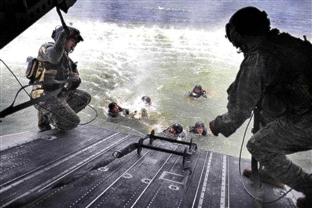 U.S. Army soldiers use a rope ladder to board a CH-47 Chinook helicopter during  a month-long joint operations and tactics course in the Gulf of Mexico, Aug. 5, 2009. The CH-47 crew is assigned to Task Force 160th Special Operations Aviation Regiment, Fort Bragg, N.C.