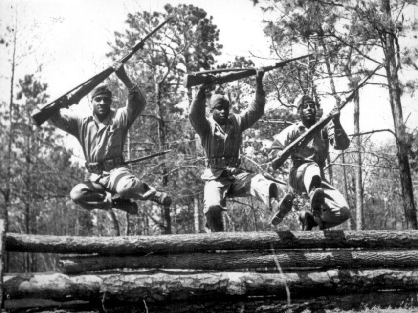 Montford Point Marines jump over an obstacle course during recruit training at Montford Point Camp, Marine Corps Base Camp Lejeune, N.C.