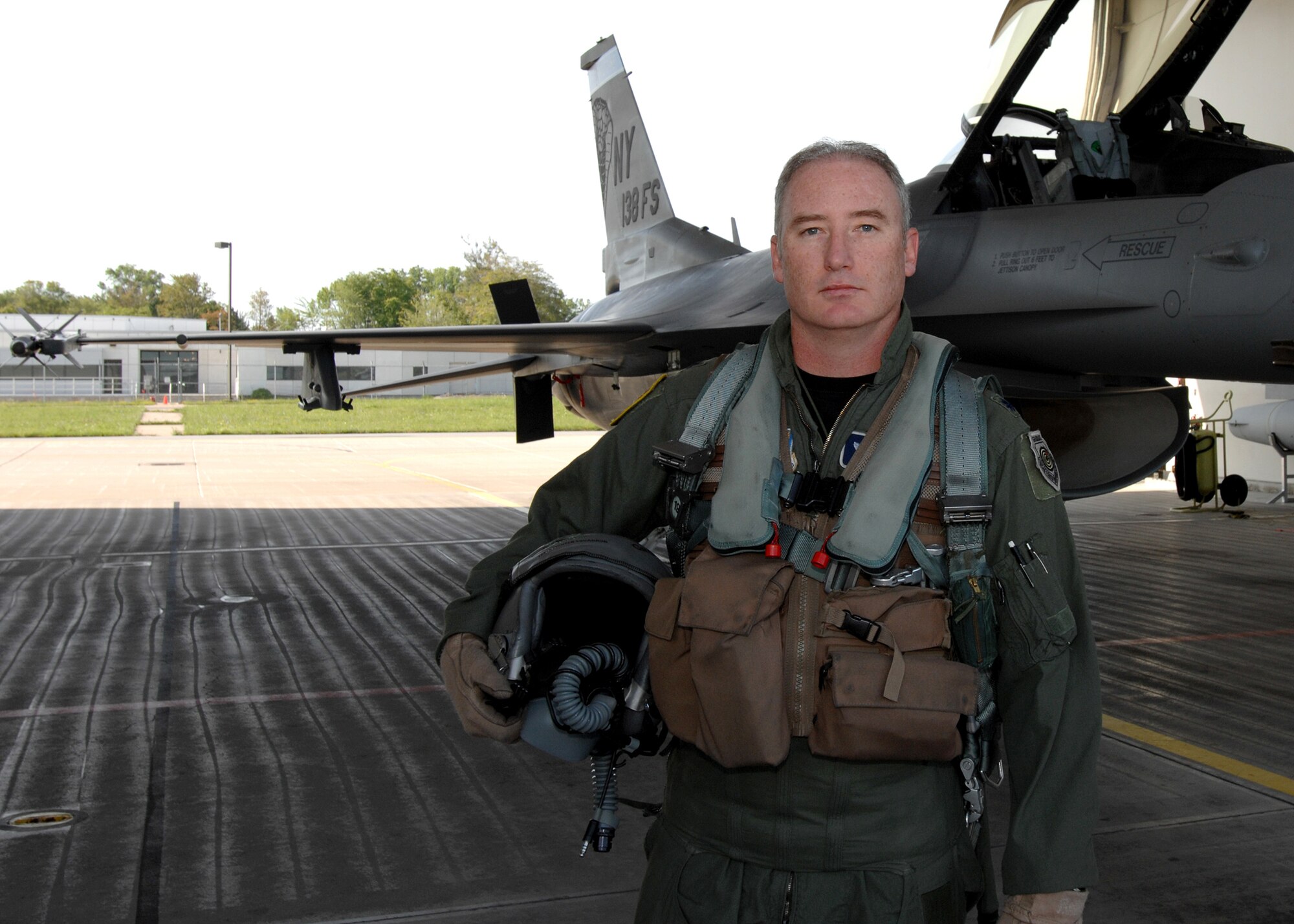 Lt. Col. D. Scott Brenton, a pilot with the 174th Fighter Wing, Hancock Field Syracuse NY, posses with the F-16 Fighting Falcon that would soon fly him past the 4,000 hour mark in the cockpit of an F-16. (USAF Photo by Staff Sgt. James N. Faso II/Released)
