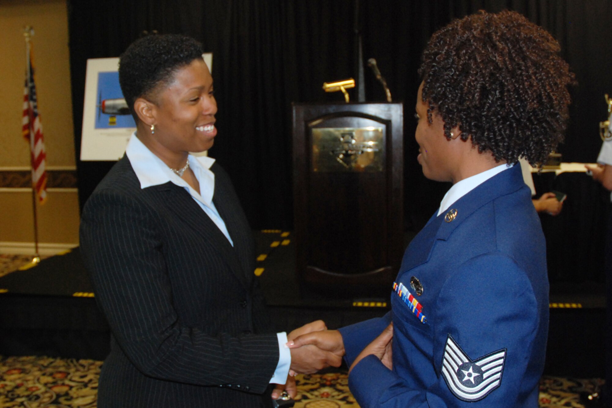 Vernice Armour, America’s First African American Female Combat Pilot exchanges words with Tech. Sgt. Larysa S. Lewis, chief, installation personnel readiness, 94th Mission Support Squadron at the 38th Annual Tuskegee Airmen Inc. Nation Convention, Palace Station Hotel, Las Vegas NV. Aug 6. (U.S. Air Force photo/Tech. Sgt. James Branch)