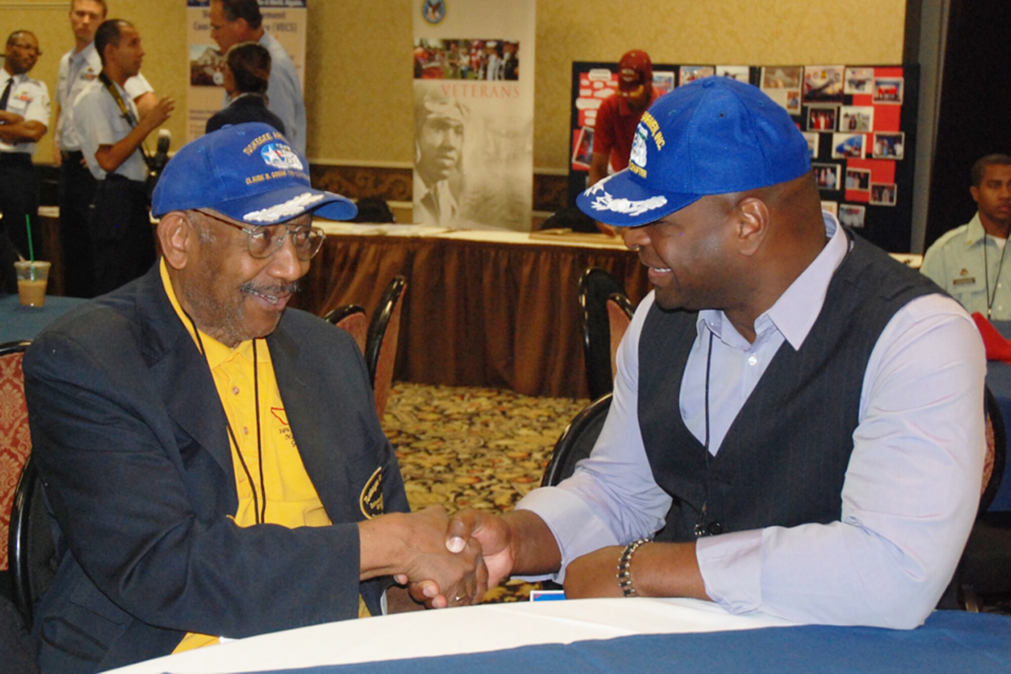 Capt. Darrell Bogan, military equal opportunity officer, 94th Airlift Wing, exchanges words with Dabney M. Montgomery of the Tuskegee Airmen Inc., New York Claude B. Govan Chapter at the 38th TAI Nation Convention, Palace Station Hotel, Las Vegas NV. Aug 6. Montgomery served as a bodyguard for Dr. Martin Luther King, Jr. during his march from Selma to Montgomery, March 21-25, 1965 and is listed as an American Hero. (U.S. Air Force photo/Tech. Sgt. James Branch)