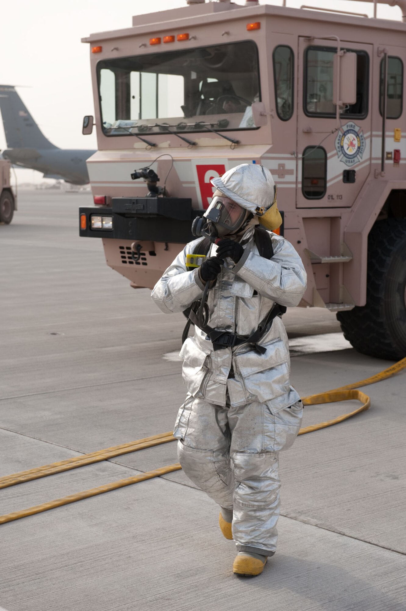 Firefighters from the 379th Expeditionary Civil Engineer Squadron conduct egress training on a simulated KC-135 engine fire, Aug. 5, in Southwest Asia. The 379 ECES firefighters respond to a wide range of emergencies and must maintain proficient on all emergency response procedures. All of the firefighters are deployed to Southwest Asia in support of Operations Iraqi and Enduring Freedom. (U.S. Air Force Photo/Staff Sgt. Robert Barney)