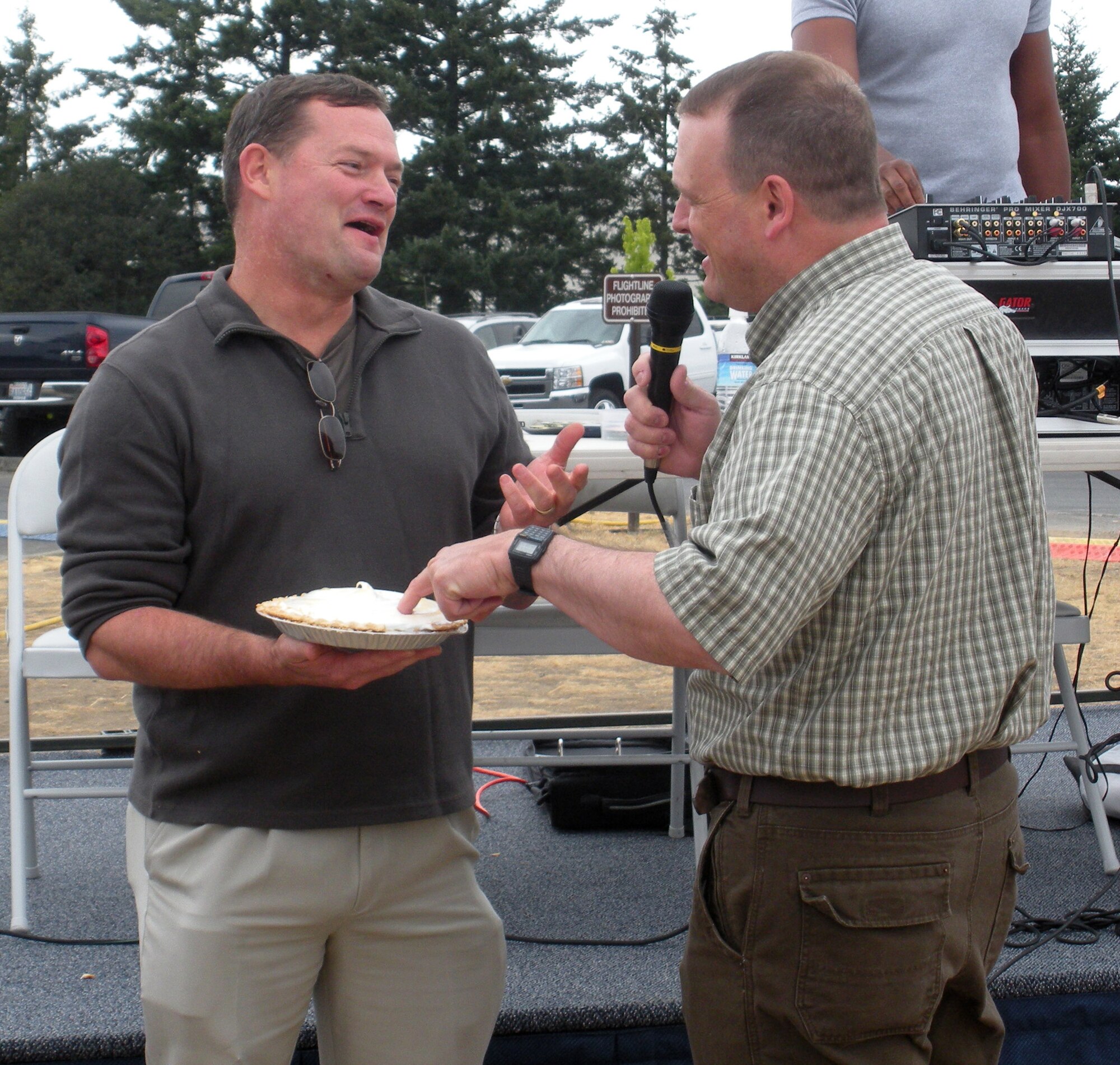 Col. David Pavey, left, 446th Operations Group commander, McChord Air Force Base, Wash., informs Col. Craig Petersen, 446th Mission Support Group commander, how he's going to introduce a pie in to Colonel Petersen's face. The Pie-in-the-Face contest was part sponsored by the 446th Mission Support Squadron's Airman and Family Readiness Center for its Care and Share program. The event took place as part of the annual 446th Airlift Wing Family Day picnic.  (U.S. Air Force photo/Shawna Pavey)