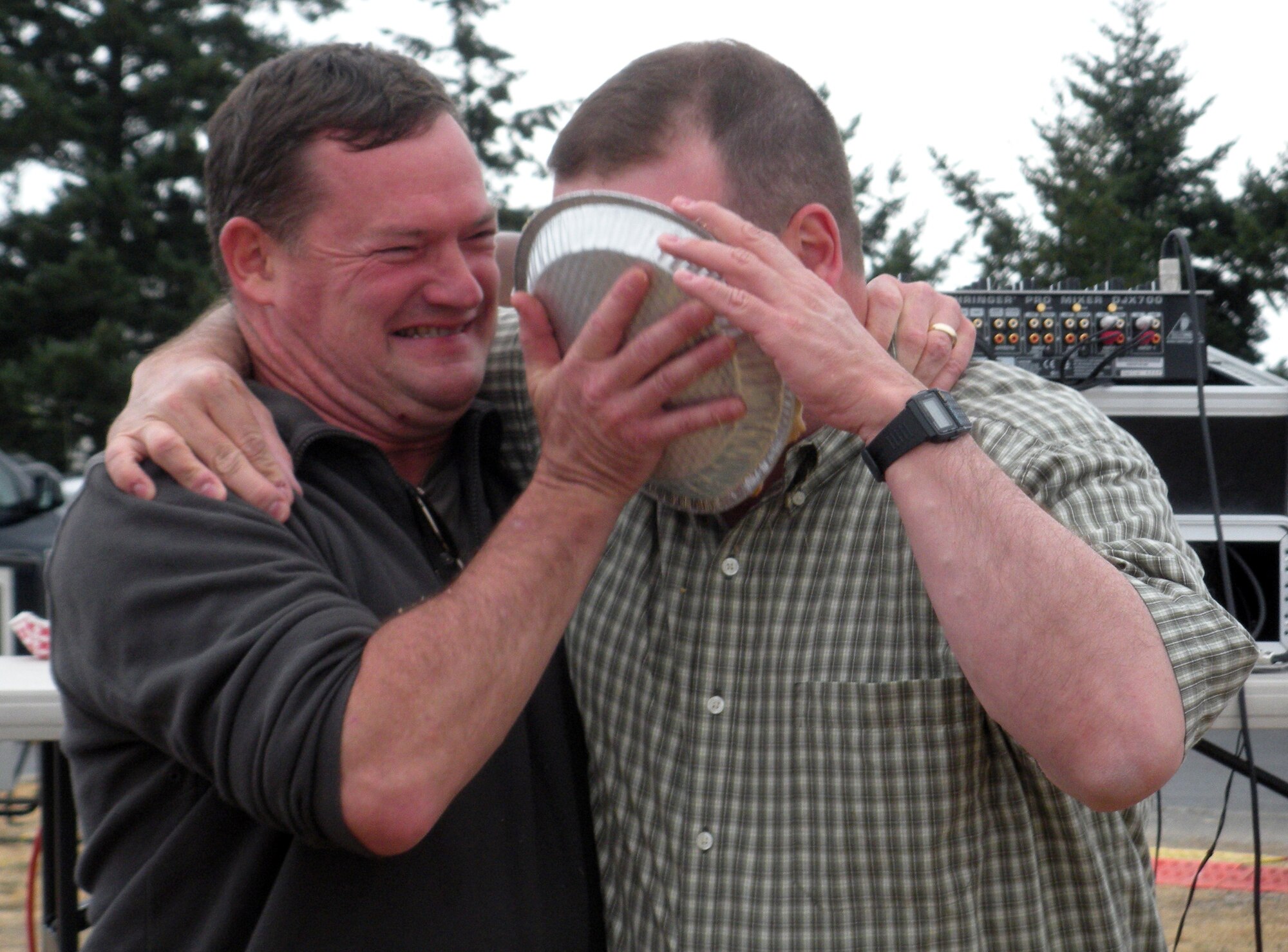 Col. David Pavey, left, 446th Operations Group commander, McChord Air Force Base, Wash., smashes a cream pie in the face of 446th Mission Support Group commander, Col. Craig Petersen, during the Pie-in-the-Face contest at the 446th Airlift Wing Family Day picnic here, Aug. 8. Proceeds from the contest benefitted the 446th MSS Airman and Family Readiness Center's Care and Share program. (U.S. Air Force photo/Shawna Pavey)                            