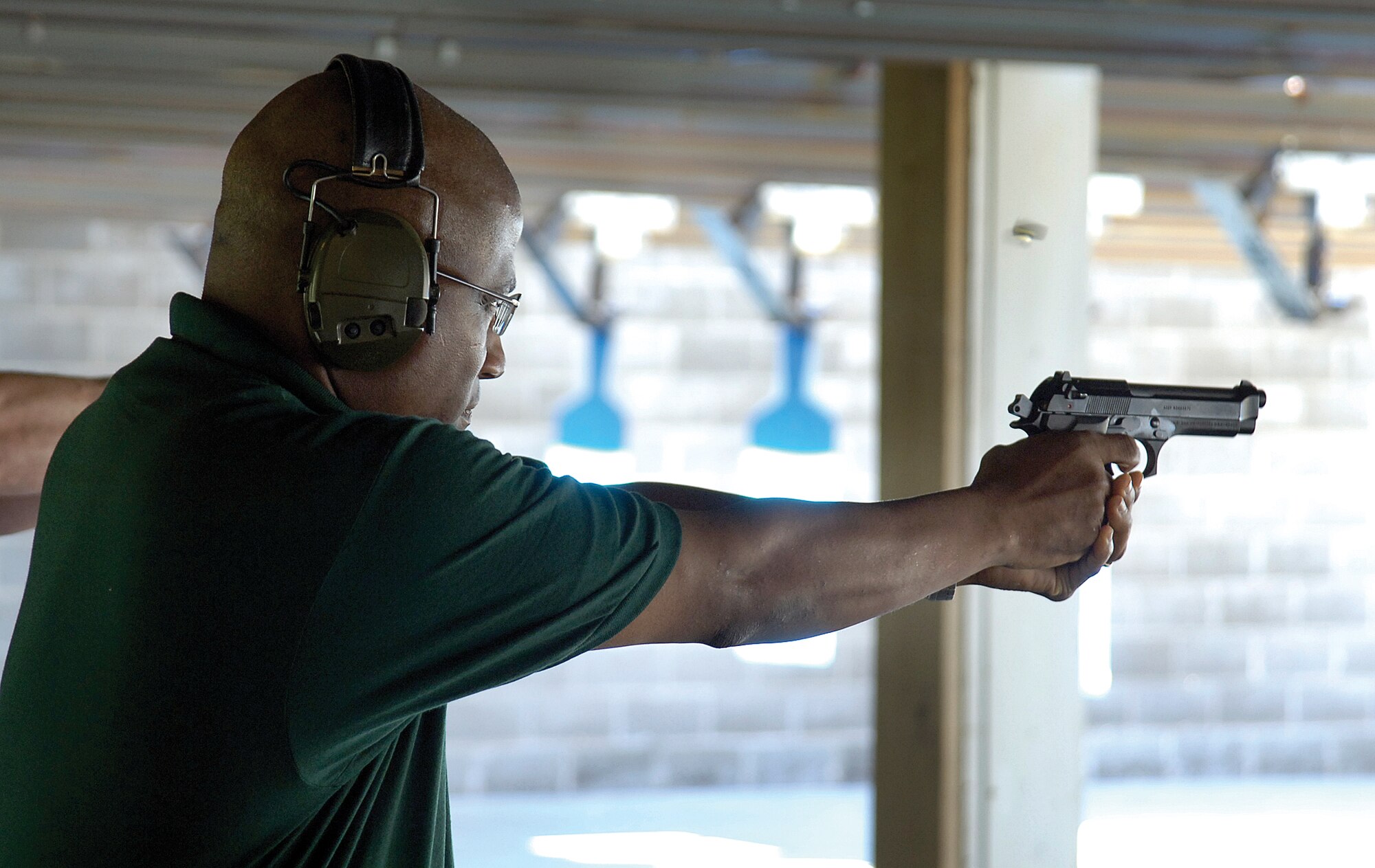 Col. Allen Jamerson, 72nd Air Base Wing and Tinker installation commander, takes aim during the competition. Colonel Jamerson took the opportunity at the competition to thank the representatives from various federal agencies for their support in criminal enforcement and national security activities.  