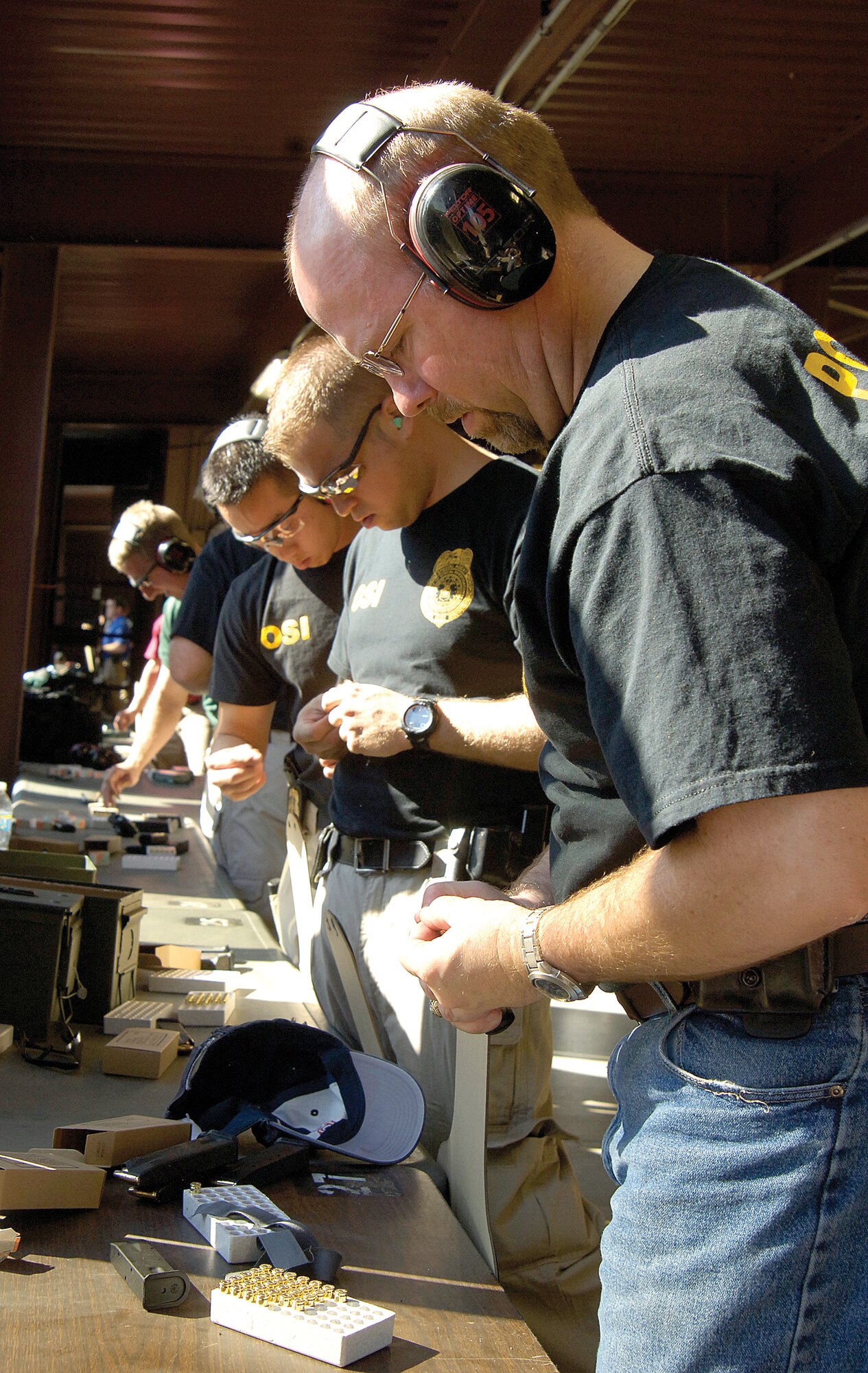 A team from the OSI loads magazines at the firing range, aiming for a win in the 12th-annual competition. The friendly, very competitive, event draws federal law enforcement personnel from many agencies including the Secret Service, FBI, U.S. Postal Service and Tinker’s own 72nd Security Forces Squadron. Pictured from front to back are; OSI special agent in charge Jack Angelo and special agents Rob Lawler and Mike Nguyen.