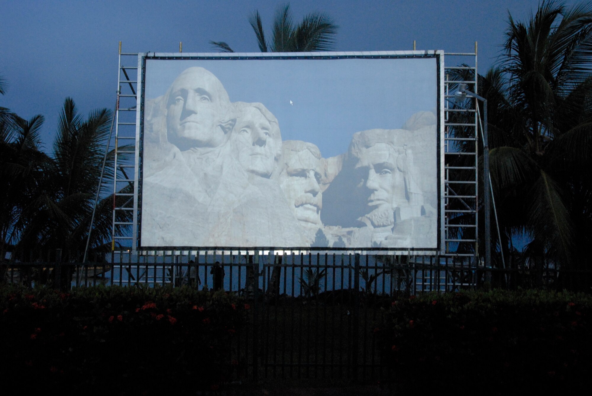 A screen projects the faces of Mt. Rushmore as firewords are displayed in the background during the 4th of July celebration at the U.S. Embassy in Suriname.
(U.S. Air Force Photo by Master Sgt Chris Stewart)