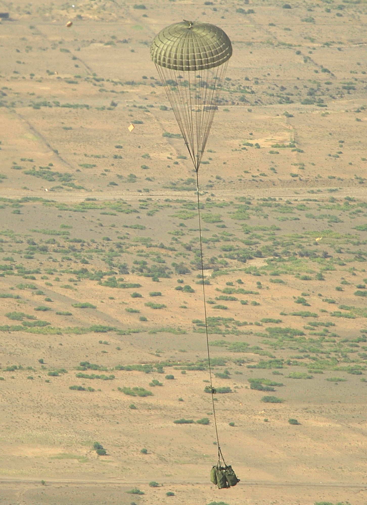 BAGRAM AIRFIELD, Afghanistan - An M198 howitzer parachutes out of an Air Force C-130H Hercules to an Army unit waiting below. The Total Force aicrew from the 774th Expeditionary Airlift Squadron delivered the artillery piece to a forward operating base in Afghanistan Aug. 8, 2009. The 36-foot long cannon will give troops the ability to send high explosive shells at insurgents threatening the peace and security of the Paktika Province. (U.S. Air Force photo by Staff Sgt. Michael B. Keller)
