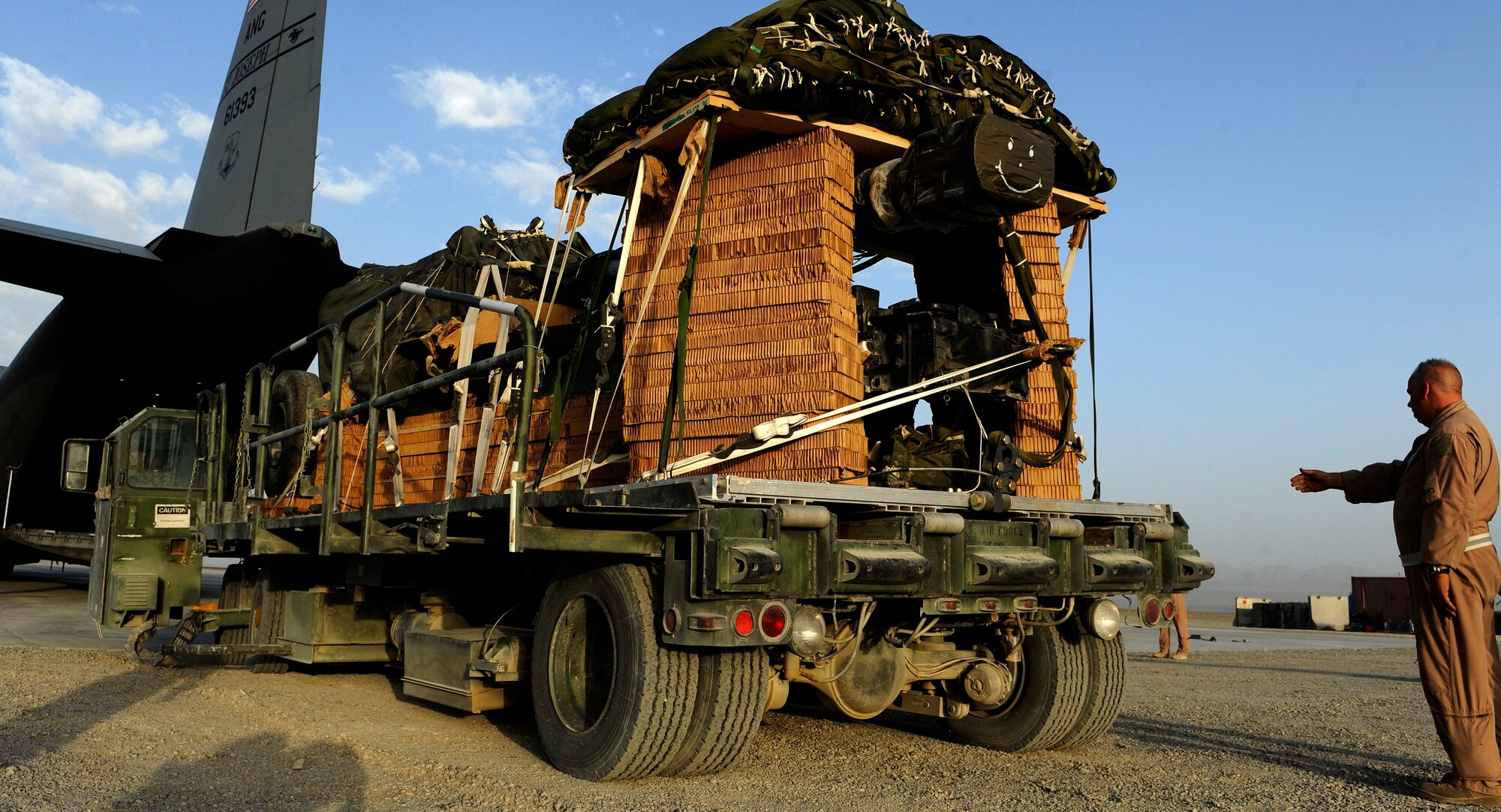 BAGRAM AIRFIELD, Afghanistan - Senior Master Sgt. Kevin Gifford loads a ten-ton pallet aboard a C-130H Hercules aircraft. Sergeant Gifford and the Total Force aicrew from the 774th Expeditionary Airlift Squadron delivered an M198 howitzer artillery piece to a forward operating base in Afghanistan Aug. 8, 2009. The 36-foot long cannon will give troops the ability to send high explosive shells at insurgents threatening the peace and security of the Paktika Province. Sergeant Gifford is a New York Air National Guardsman from Schenectady, N.Y. (U.S. Air Force photo by Staff Sgt. Michael B. Keller)