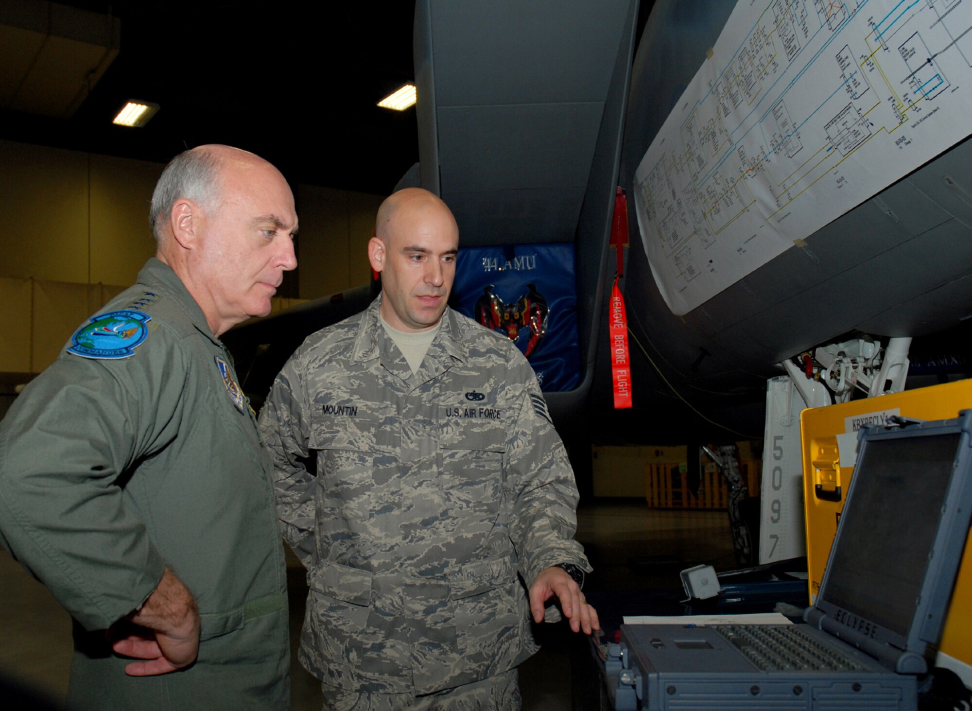 Gen. Carrol "Howie" Chandler, Pacific Air Forces commander, gets a briefing on a wire analyzer from Staff Sgt. Ronald Mountin, NCO in charge of the 18th Wing Wire Analysis Team. The equipment allows maintainers to check multiple circuit connections and components on aircraft in a matter of seconds. (U.S. Air Force photo/Airman 1st Class Ryan Ivacic)
