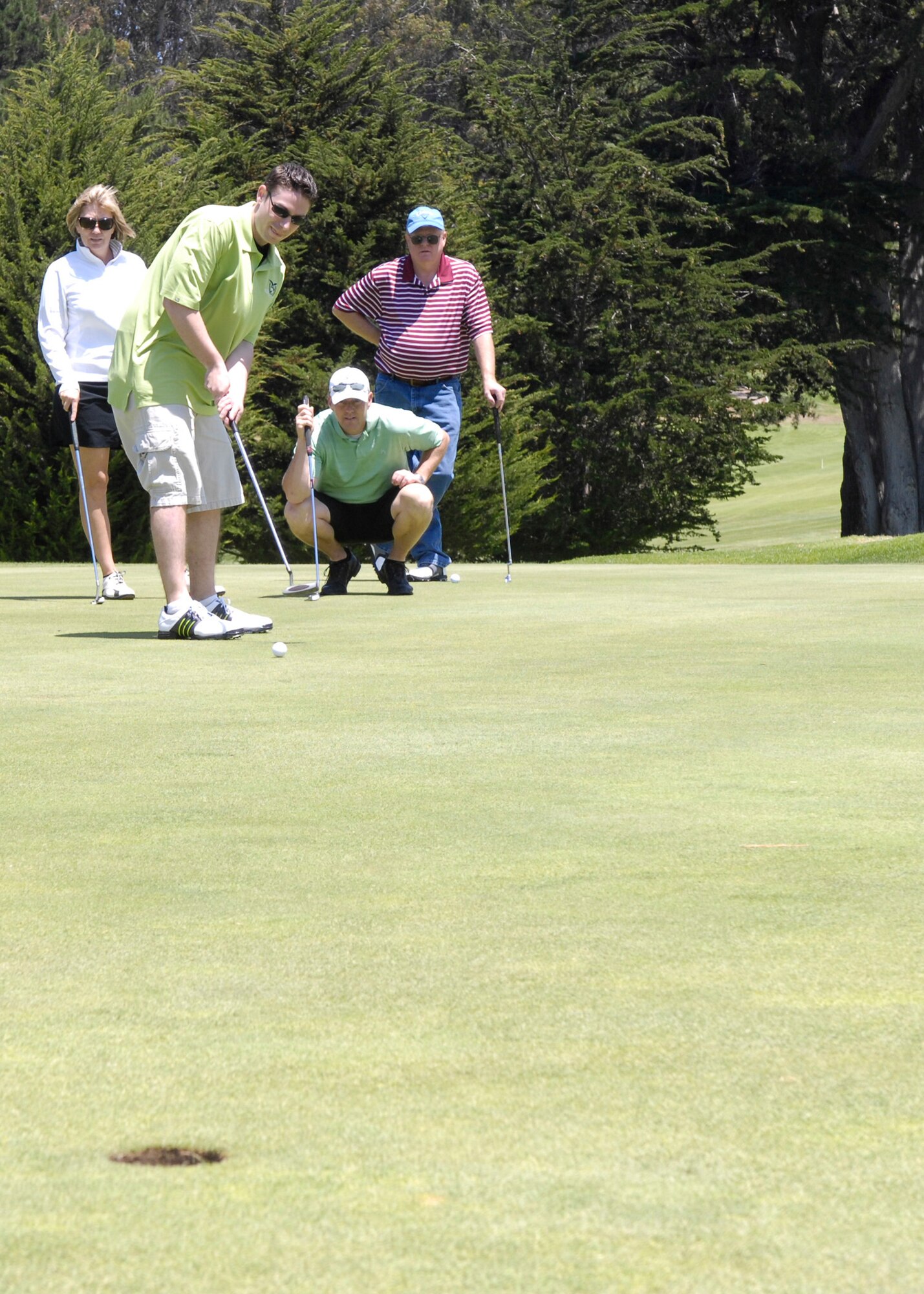 The Air Force Association Golf Tournament winning team: Jon Stimpson (putting), Tracy Watkins, (kneeling), Betsy Watkins and Mr. Jim Sorrells.  The tournament was held at the Marshallia Ranch Golf Course Aug. 7. (U.S. Air Force photo/Staff Sgt. Scottie T. McCord)
