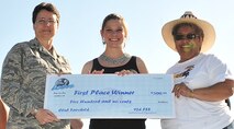 FAIRCHILD AIR FORCE BASE, Wash.–Capt. Manuela Peters, 93rd Air Refueling Squadron pilot, accepts a check for $500 from Col. Suzanne Filion, 92nd Mission Support Group commander, and Doreen Smith, Club Fairchild manager, after winning first place at the Air Mobility Command Icon preliminary screening competition at Miller Park July 30. Captain Peters will compete at Scott Air Force Base, Ill., for the major-command level competition. The second place winner was Molly Chapman; and the third place finisher, Javar Bailey.  (U.S. Air Force photo / Staff Sgt. James May III)