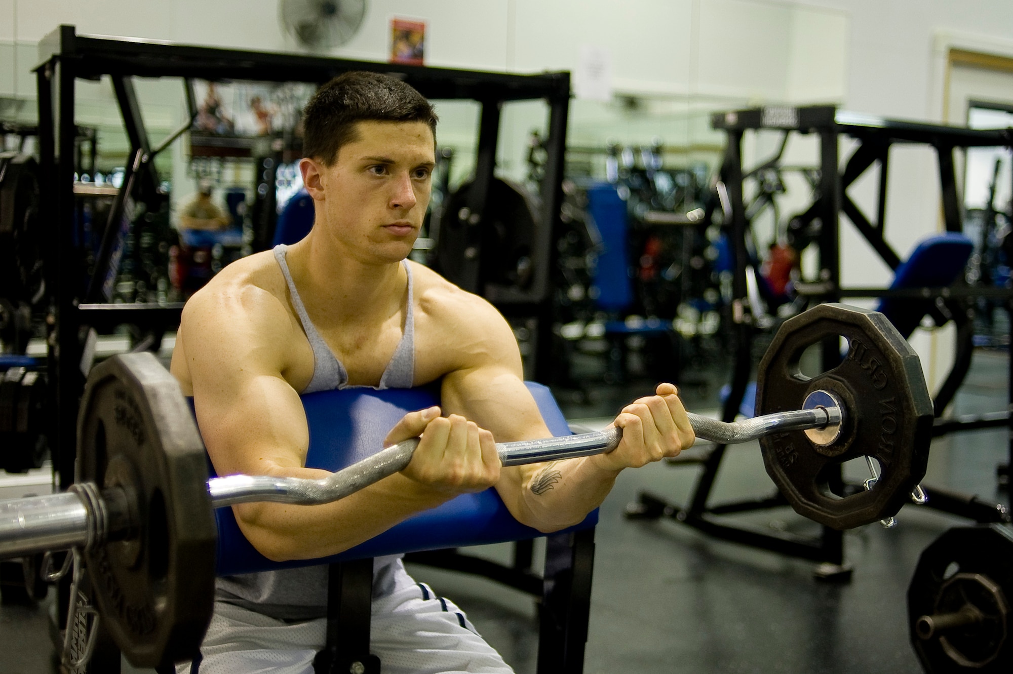 Airman 1st Class Ryan Timm, 62nd Logistics Readiness Squadron, trains at the base fitness center weight room. Airman Timm competed in a local bodybuilding competition in August. (U.S. Air Force Photo/Abner Guzman)