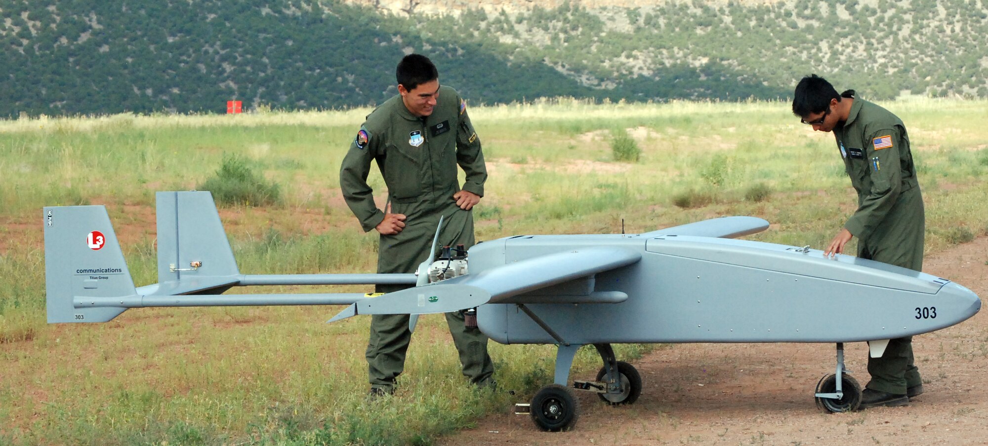 Air Force Cadets 2nd Class Jeffrey Nakayama and Rupert Domingo inspect a Viking 300 unmanned aerial vehicle before launch from Camp Red Devil at Fort Carson, Colo., July 20, 2009. The U.S. Air Force Academy's new Unmanned Aerial System training is designed to encourage cadets to serve as UAS leaders after graduation. The Viking 300 weighs between 200 and 300 pounds and has a top speed of 100 knots, with a cruising speed of 55 knots. (U.S. Air Force photo/Ann Patton)