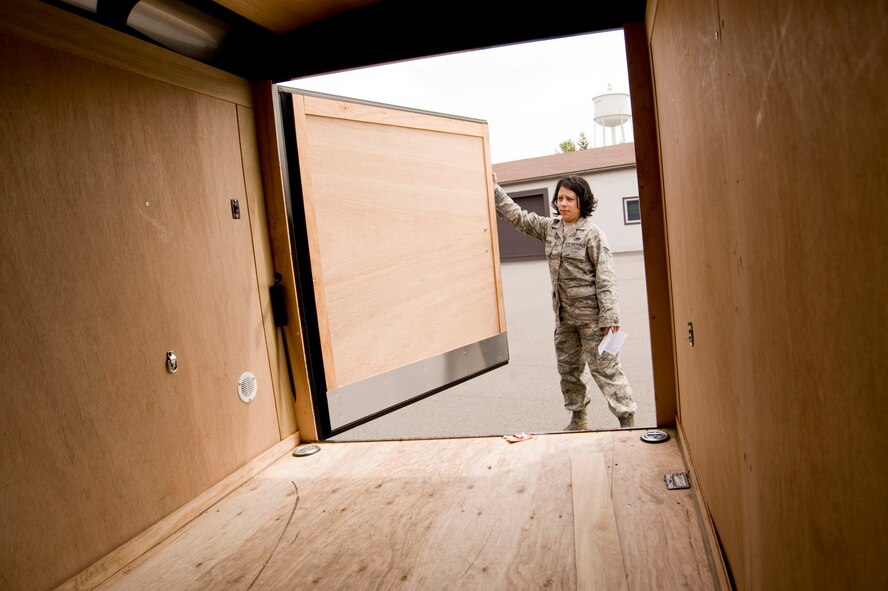 Senior Airman Azucena Jordan, 62nd LRS, performs a routine pre-trip inspection of a cargo trailer used primarily to transport baggage during aircrew runs. (U.S. Air Force Photo/Abner Guzman)