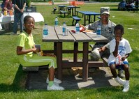 FAIRCHILD AIR FORCE BASE, Wash.–Tech. Sgt. Cheryl White, 92nd Air Refueling Wing paralegal, and her children Ashlee (left), 11, and Mya (right), 7, enjoy lunch at the Base Picnic in Miller Park July 30. (U.S. Air Force photo / Senior Airman Joshua K. Chapman)