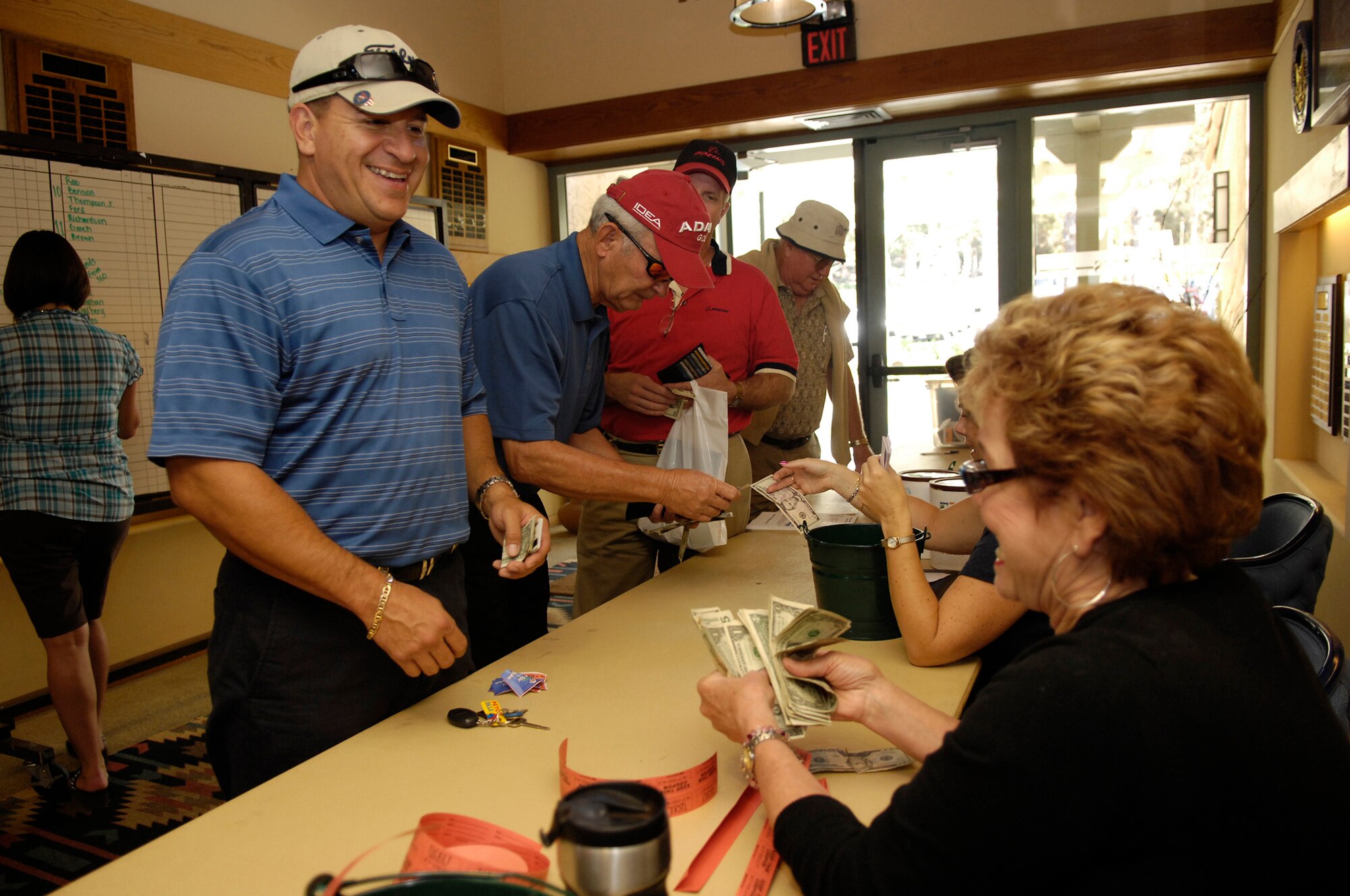 Senior Master Sgt. Edward Palacios, from the 532nd Training Squadron, purchases raffle tickets during the registration for the Air Force Association Golf Tournament.  The tournament was held at the Marshallia Ranch Golf Course Aug. 7.
(U.S. Air Force photo/Staff Sgt. Scottie McCord)