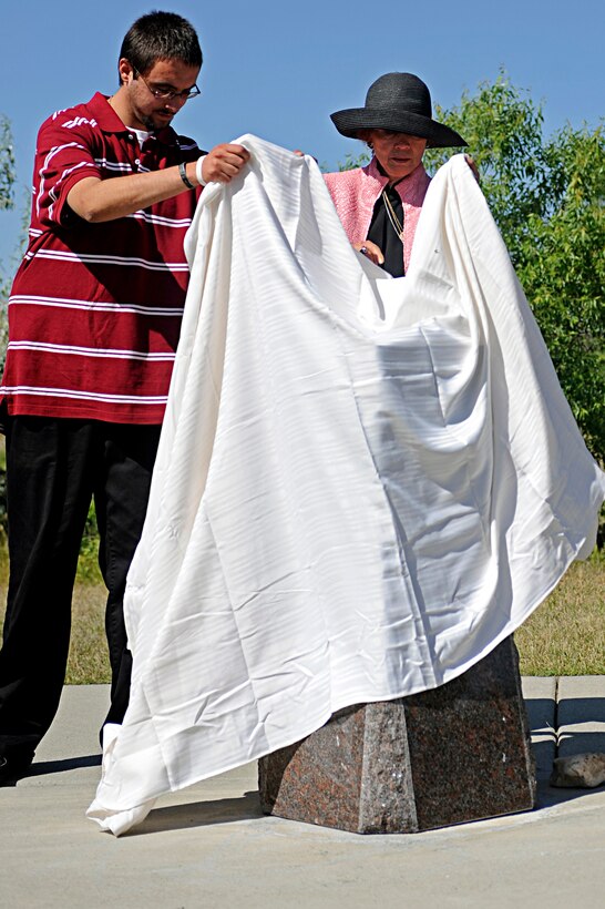 (Left) Matthew Yelner and Yolanda Vega unveil a pillar dedicated to Senior Airman Jonathan Yelner, 28th Aircraft Maintenance Squadron weapons load crew member, here, August 7. Airman Yelner was killed in action in April 2008. (U.S. Air Force photo/Airman 1st Class Matthew Flynn)