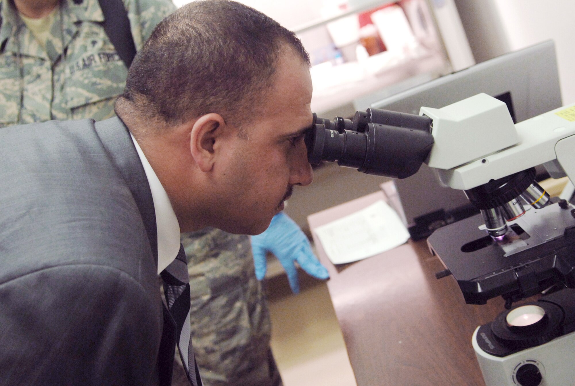 Iraqi Salah Ad Din Province Deputy Governor Ahmed al-Krayem views a sample through a microscope at the Air Force Theater Hospital's laboratory Aug. 5 at Joint Base Balad, Iraq. The Iraqi dignitary visited the AFTH and the Sgt. Ivory L. Phipps Clinic here to gather ideas for improving health care for his constituents. (U.S. Air Force photo/Senior Airman Christopher Hubenthal)