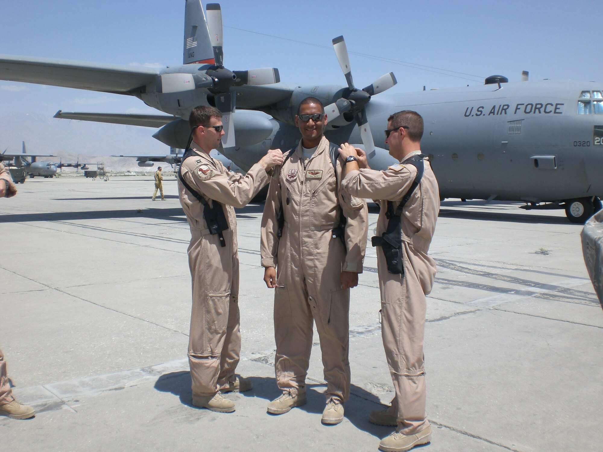 Capt. Erik Smith is promoted to Major on the Flight Line at an Air Base in Afghanistan by Capt. Chad Bannworth and Capt. Jason Lehman.