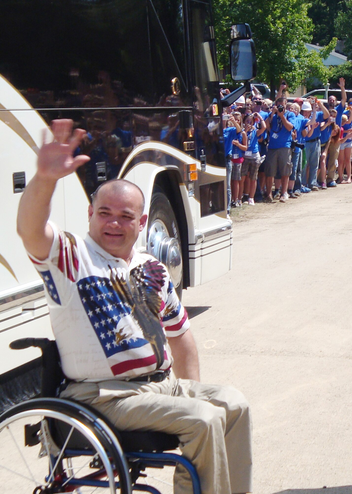 James Terpenning waves to volunteers and onlookers after seeing his new home unveiled as part of the television show "Extreme Makeover: Home Edition." (U.S. Air Force photo/Ron Fry)