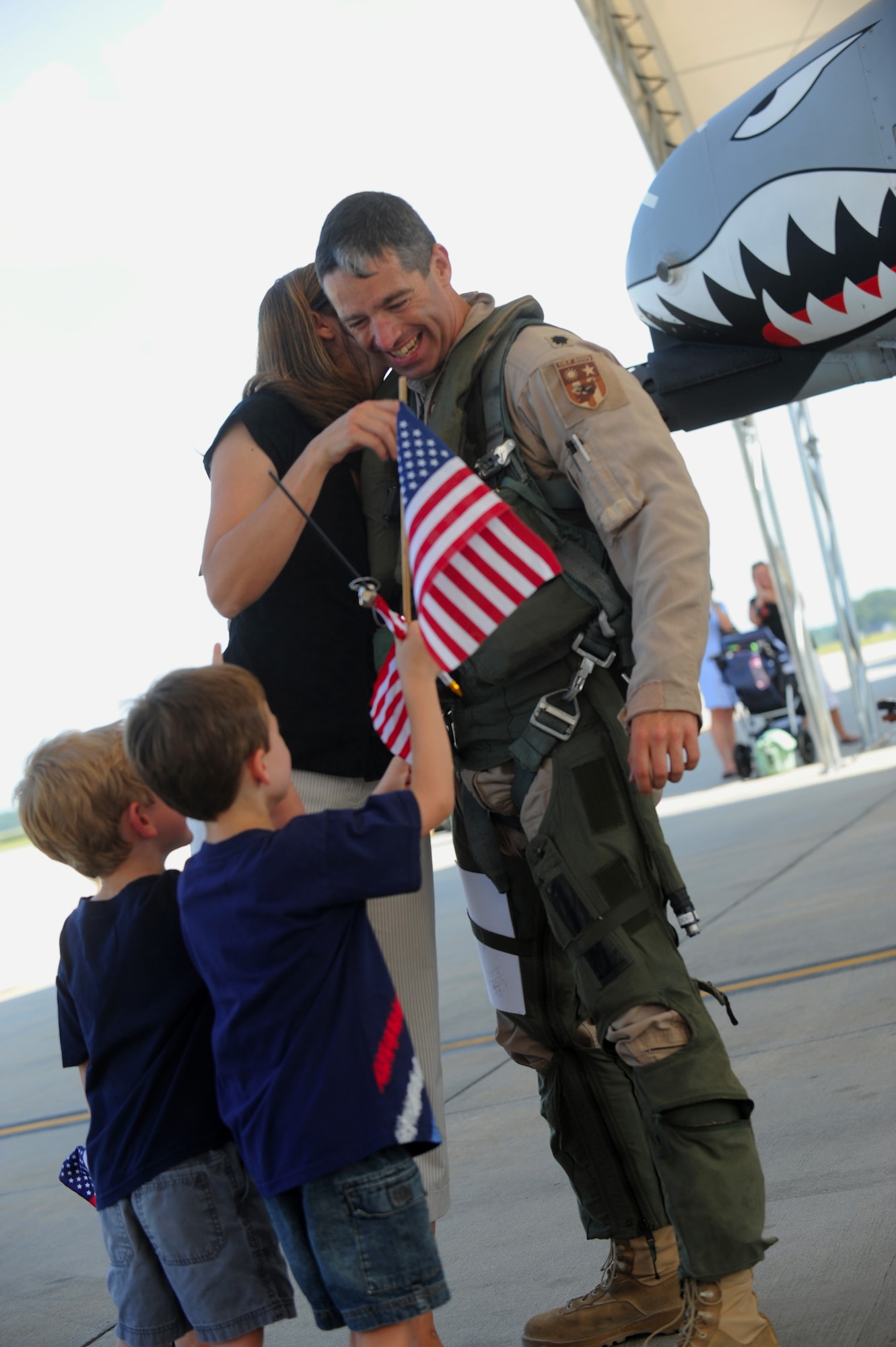 MOODY AIR FORCE BASE, Ga. -- Lt. Col. Patrick McKeever, 74th Fighter Squadron A-10C Thunderbolt II pilot, is greeted by his wife and children after returning from a deployment to Afghanistan here Aug. 9. (U.S. Air Force photo by Senior Airman Gina Chiaverotti-Paige)
