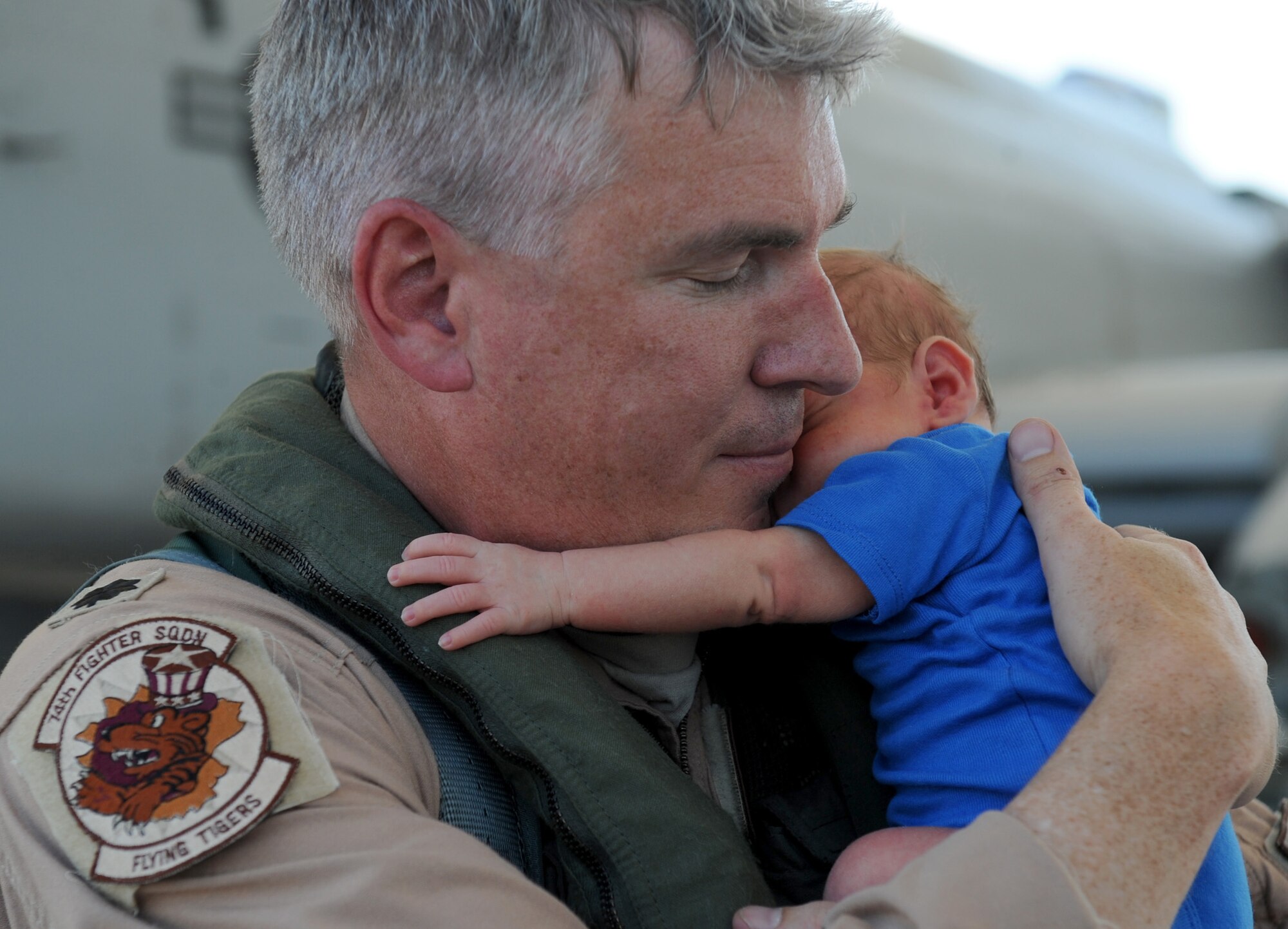 MOODY AIR FORCE BASE, Ga. -- Lt. Col. Philip Wielhouwer, 74th Fighter Squadron commander, holds his three-week old son Ryan for the first time after returning from a deployment to Afghanistan here Aug. 9. (U.S. Air Force photo by Senior Airman Gina Chiaverotti-Paige) 