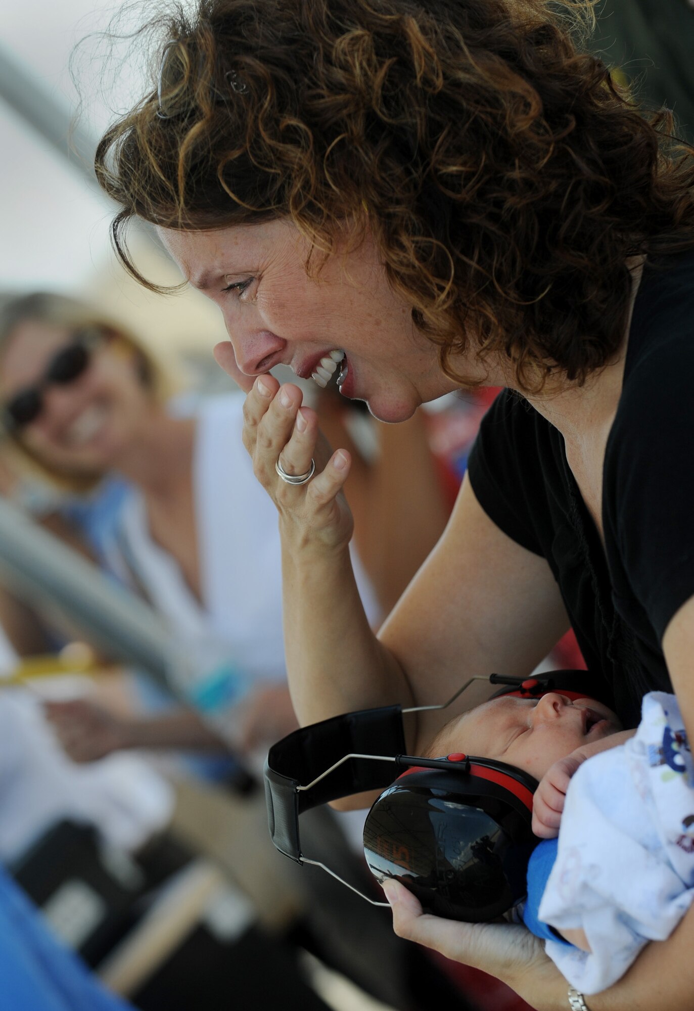 MOODY AIR FORCE BASE, Ga. -- Valarie, wife of Lt. Col. Philip Wielhouwer, 74th Fighter Squadron commander, holds her three-week old son Ryan, as she sees her husband for the first time following his deployment to Afghanistan here Aug. 9. The colonel will meet his son for the first time during the reunion. (U.S. Air Force photo by Senior Airman Gina Chiaverotti-Paige) 