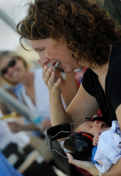 MOODY AIR FORCE BASE, Ga. -- Valarie, wife of Lt. Col. Philip Wielhouwer, 74th Fighter Squadron commander, holds her three-week old son Ryan, as she sees her husband for the first time following his deployment to Afghanistan here Aug. 9. The colonel will meet his son for the first time during the reunion. (U.S. Air Force photo by Senior Airman Gina Chiaverotti-Paige) 
