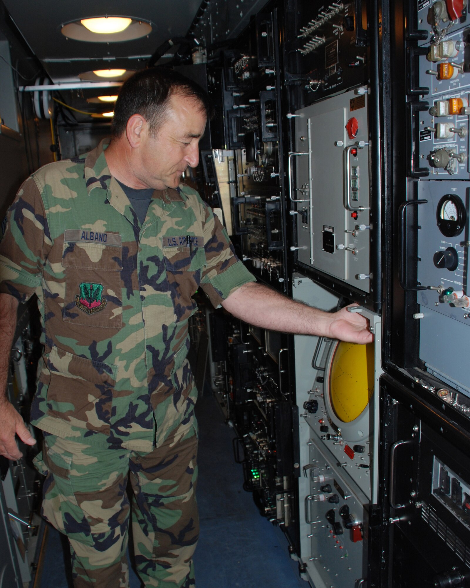 Chief Master Sgt. Denny Albano turns on the air traffic control radar system for the last time on his last day of military service.  Chief Albano retired in June after a career that spanned more than 25 years.