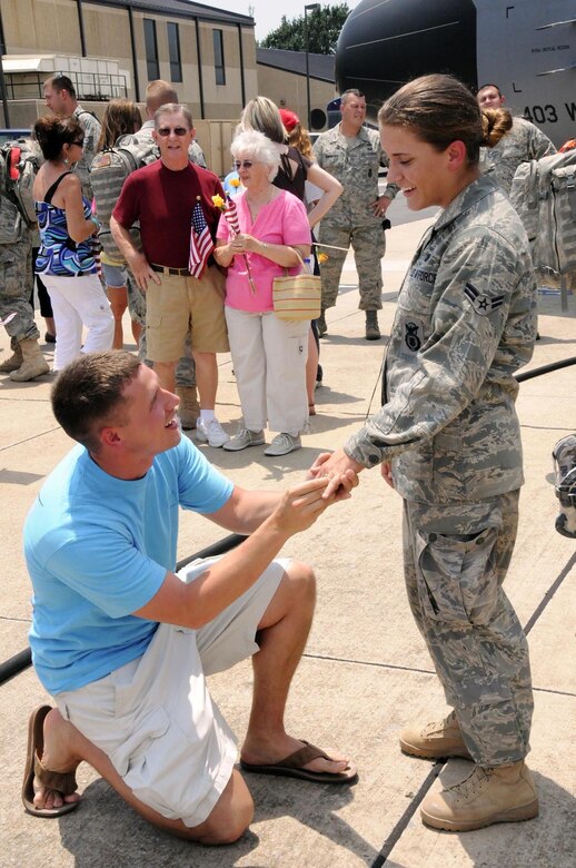 Brian Hickman proposes to his girlfriend, Senior Airman Gabriella Brewer, at Keesler Air Force Base, Miss., on Aug. 6, 2009. Airman Brewer, a 403rd Security Forces Squadron reservist, returned to Keesler the same day after a six-month deployment to Kirkuk Regional Air Base, Iraq. (U.S. Air Force photo/ Staff Sgt. Tanya King)