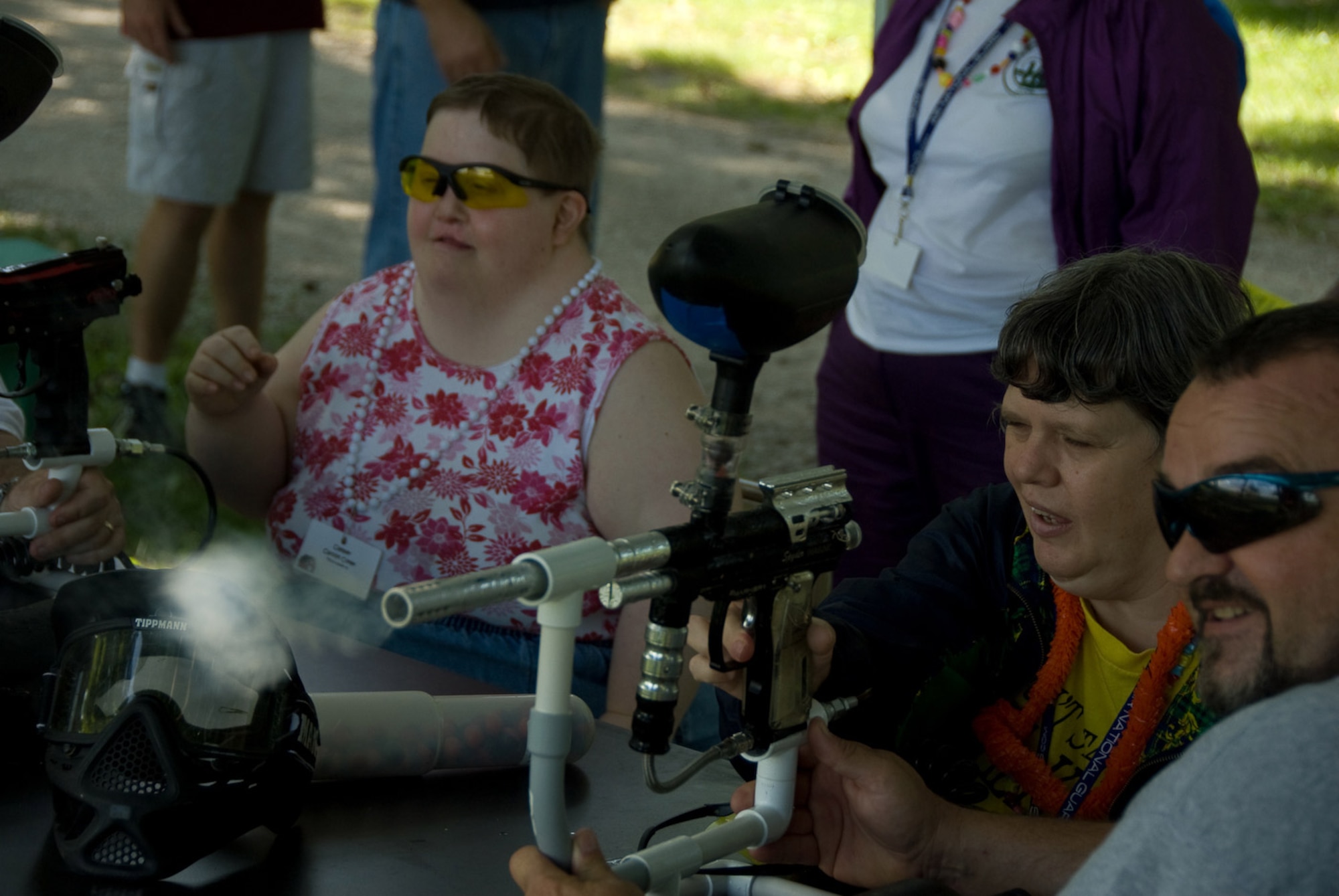 Campers and volunteers shoot paint ball guns at Camp Guardian during the 2009 session.