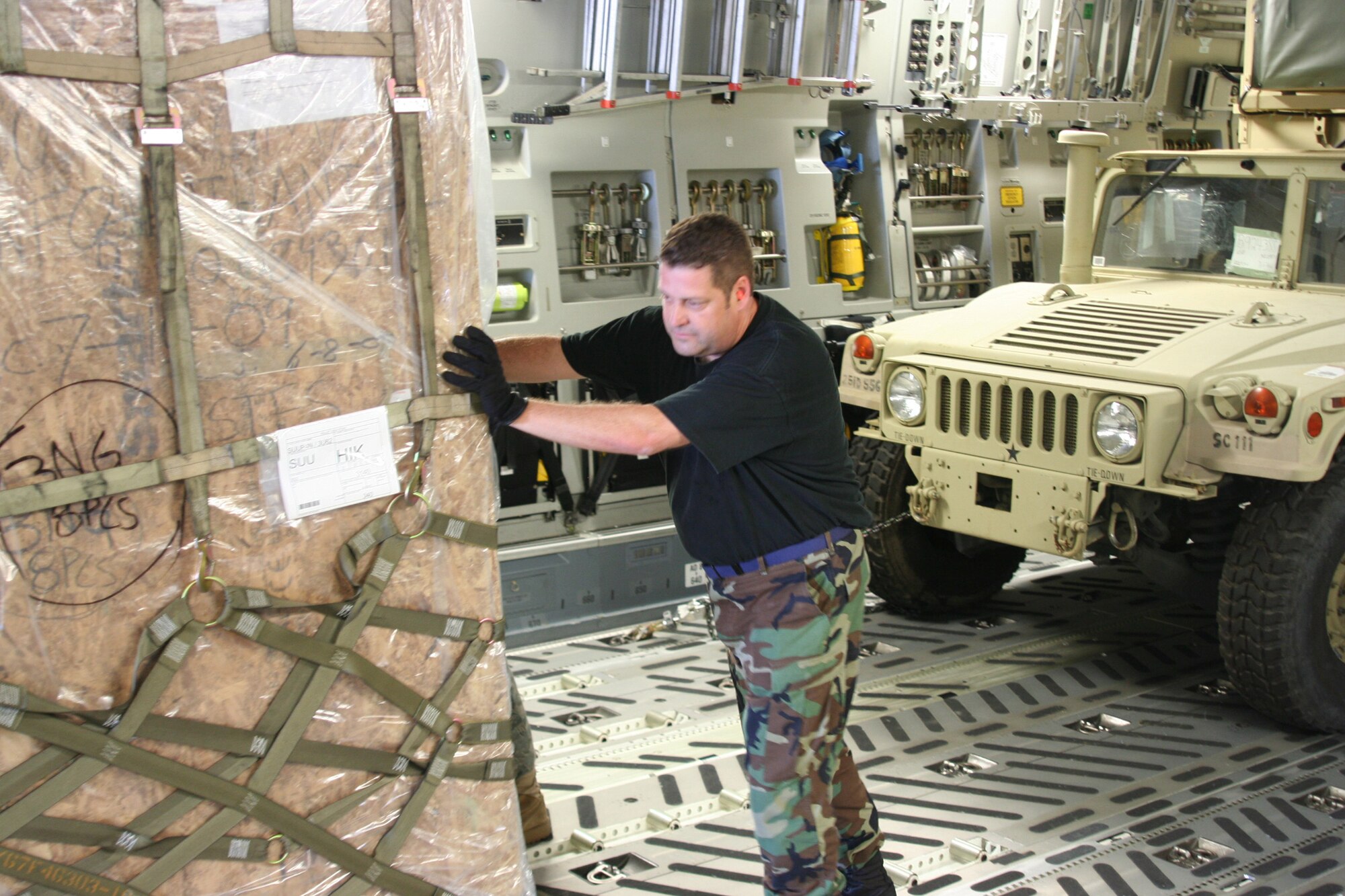 WRIGHT-PATTERSON AIR FORCE BASE, Ohio – Senior Airman Russ Hernandez, 87th Aerial Port Squadron, off loads cargo from a C-17 Globemaster III during his annual tour with the 87th APS while the unit was deployed to Hickam Air Force Base, Hawaii.  Airman Hernandez and 26 reservists with the 87th APS performed their annual tour at Hickam July 25 to Aug. 8. (U. S. Air Force photo/Senior Airman Robert Nelson)