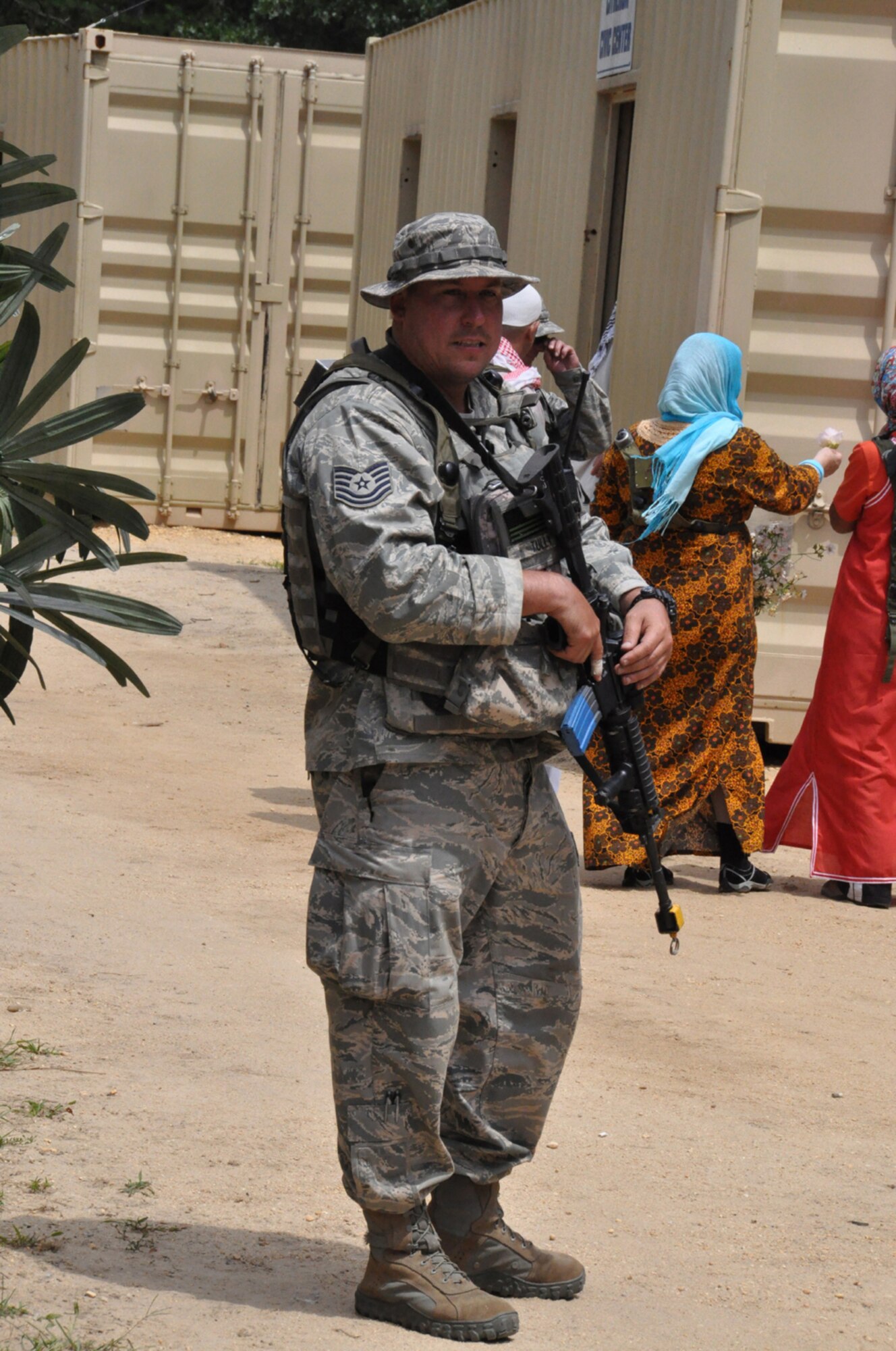 The Protector:Tech. Sgt. Thomas Tully, a security forces Airmen with the 817th Contingency Response Group, stands guard while Airmen purchase supplies and distribute humanitarian aid during EAGLE FLAG, a joint exercise held Aug. 1-9 at Lakehurst Naval Air Engineering Station, N.J.  The exercise focused on the Joint Task Force-Port Opening mission which utilized the Air Force's 621st Contingency Response Wing and the Army's 597th Transportation Group to deliver and distribute equipment and supplies during a humanitarian relief operation. (U.S. Air Force photo/Capt. Dustin Doyle)