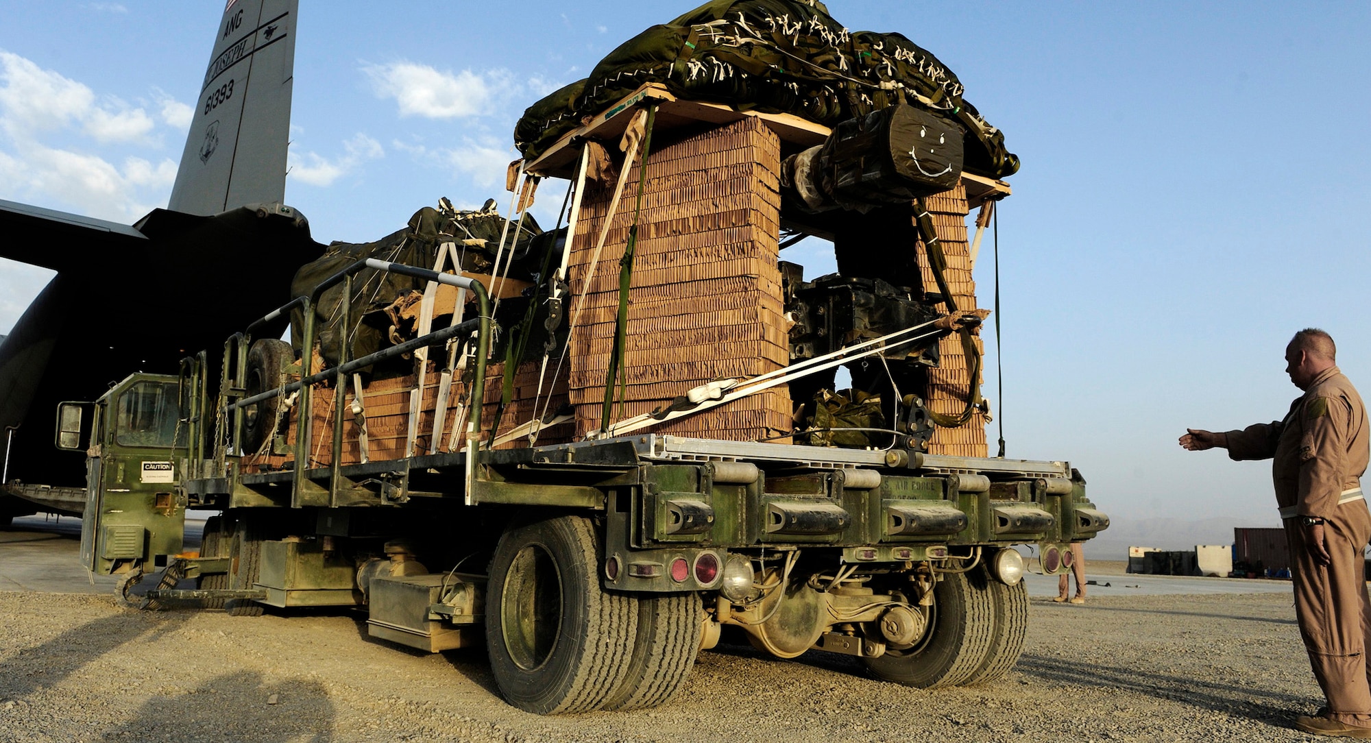 Senior Master Sgt. Kevin Gifford loads a 10-ton pallet aboard a C-130 Hercules Aug. 8 at Bagram Airfield, Afghanistan. Sergeant Gifford and an Army and Air Force aircrew from the 774th Expeditionary Airlift Squadron delivered an M198 howitzer artillery piece to a forward operating base in Afghanistan. The 36-foot long cannon will give troops the ability to send high-explosive shells at insurgents threatening the peace and security of the Paktika Province. Sergeant Gifford is a New York Air National Guard member from Schenectady, N.Y. (U.S. Air Force photo/Staff Sgt. Michael B. Keller) 
