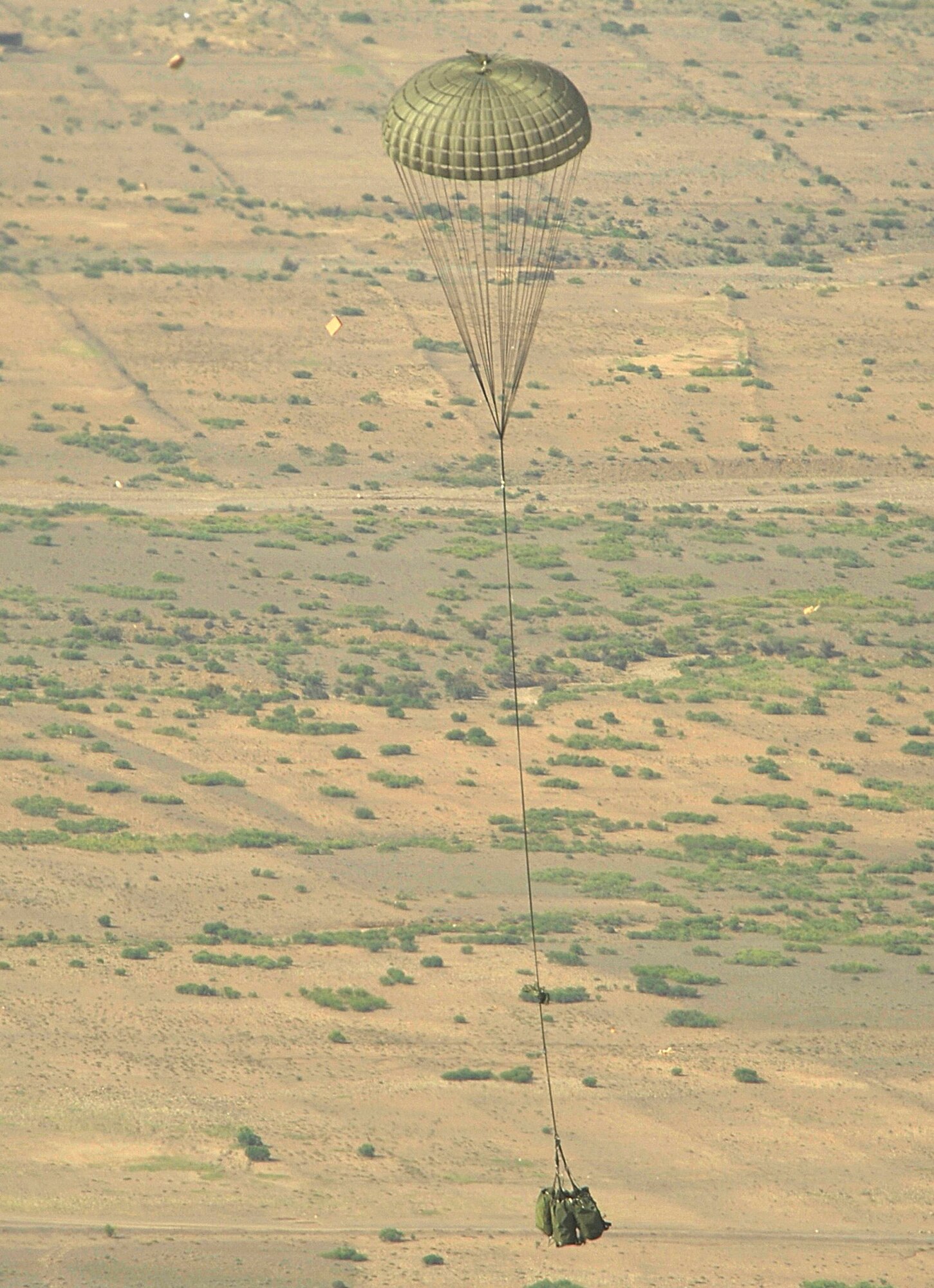 An M198 howitzer parachutes out of an Air Force C-130 Hercules to an Army unit waiting below Aug. 8 in Afghanistan. An Army and Air Force aicrew from the 774th Expeditionary Airlift Squadron delivered the artillery piece to a forward operating base in Afghanistan. The 36-foot long cannon will give troops the ability to send high-explosive shells at insurgents threatening the peace and security of the Paktika Province. (U.S. Air Force photo/Staff Sgt. Michael B. Keller)